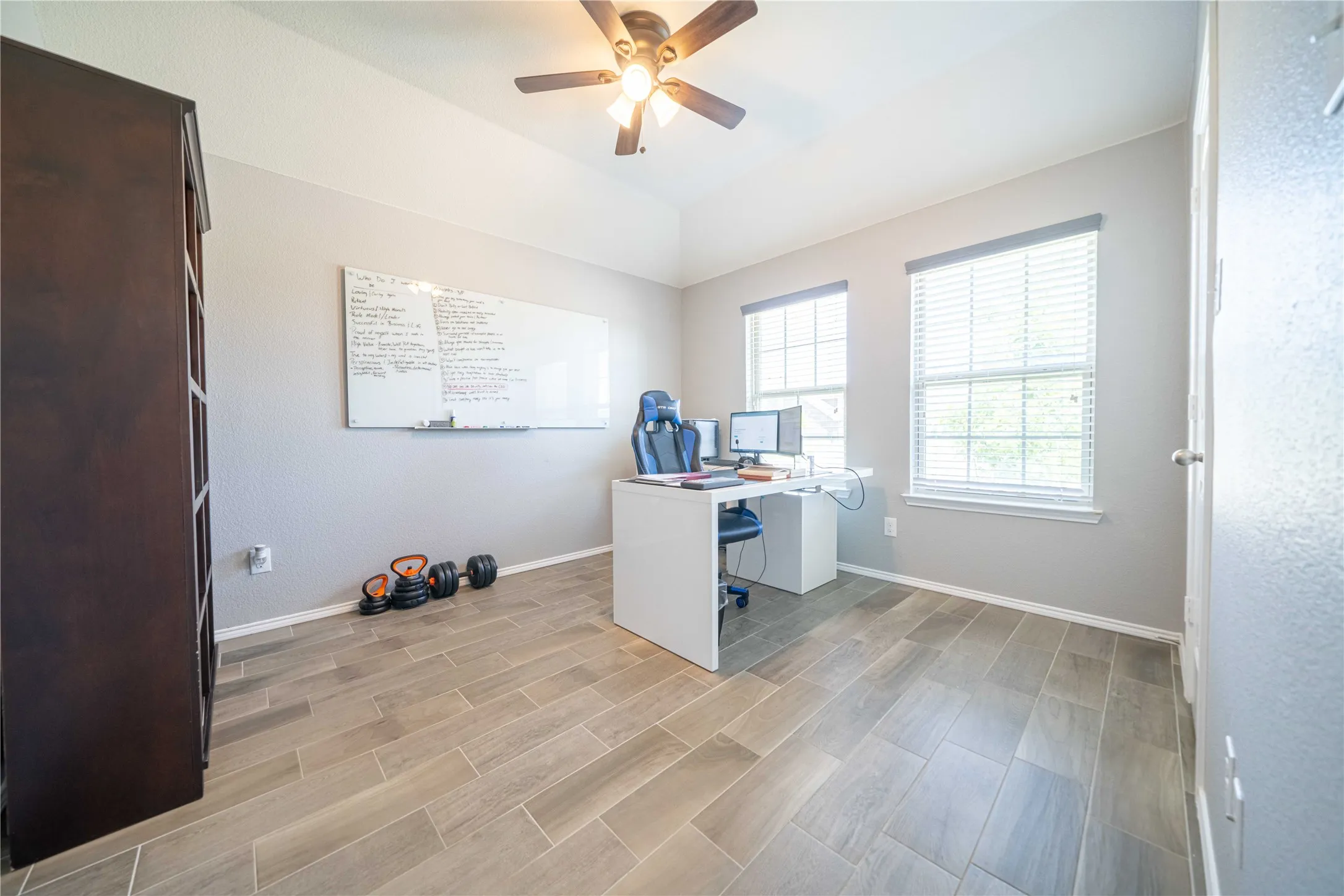 Home office featuring light hardwood / wood-style floors and ceiling fan