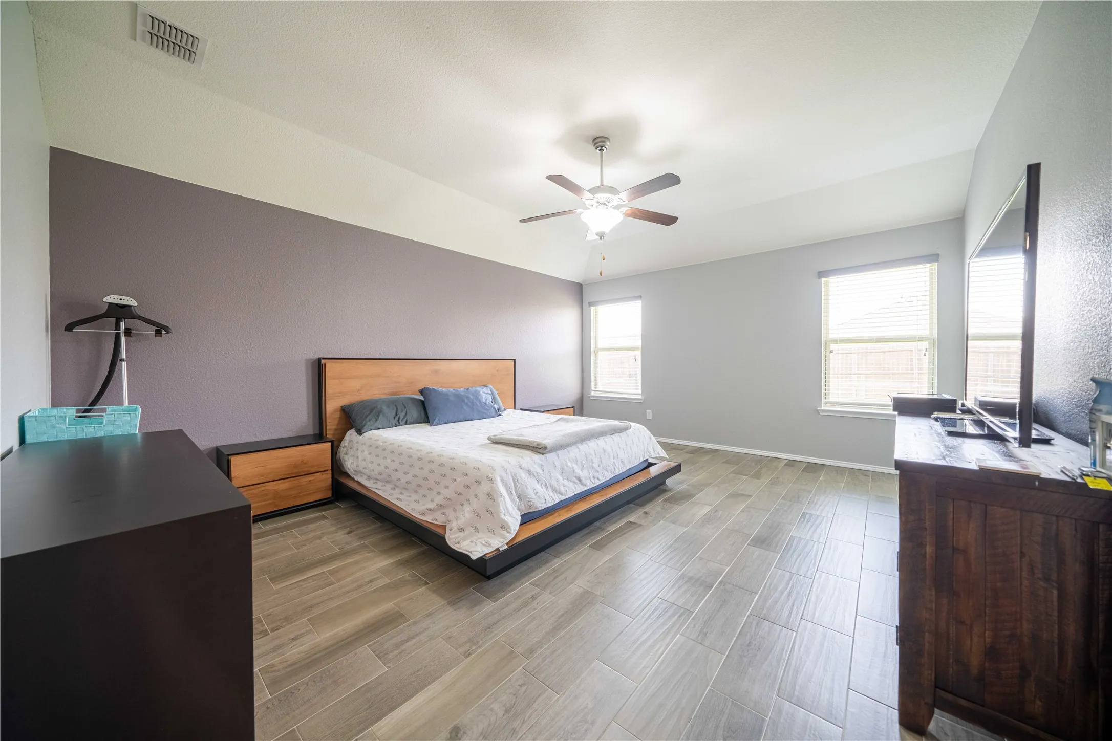 Bedroom with light hardwood / wood-style flooring and ceiling fan