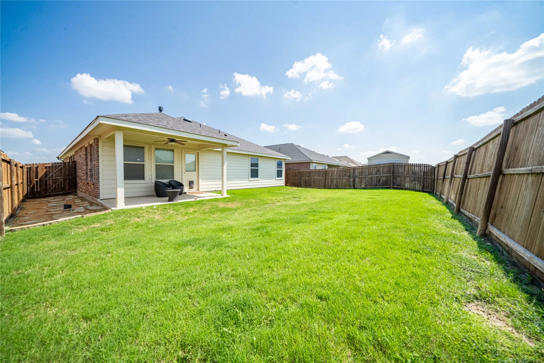 View of yard featuring a patio area and ceiling fan