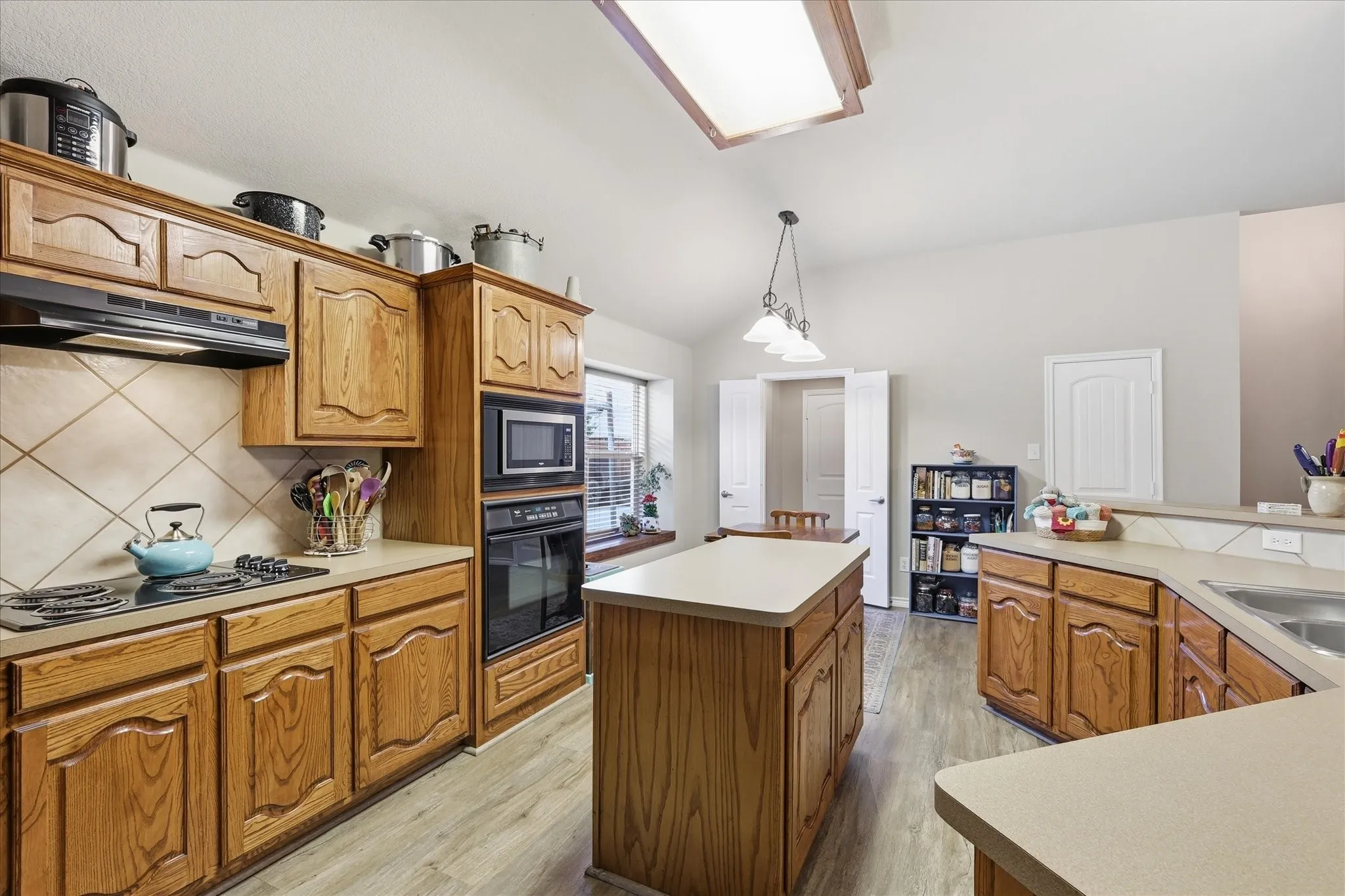 Kitchen featuring natural wood countertops and center island.
