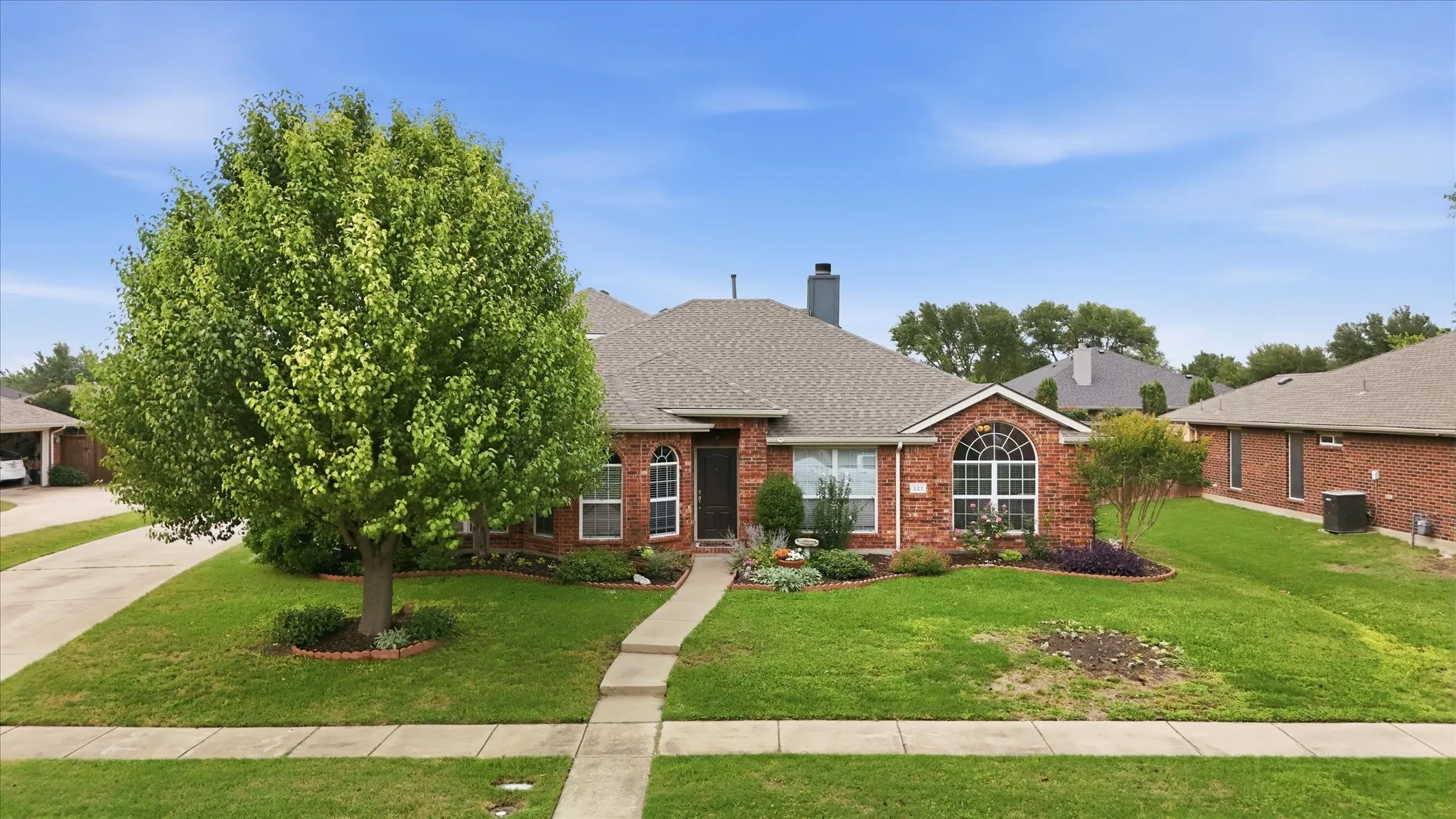 Front of House with side entry garage & long drive way