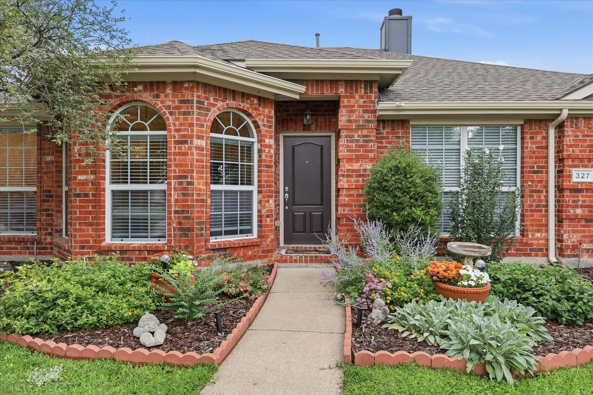 Front of House and landscaped flower beds.
