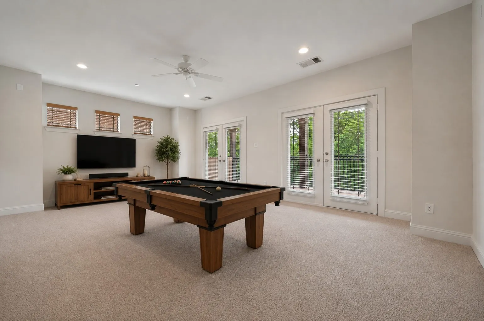 The third floor room has two french doors that open up to a large balcony overlooking the greenbelt and tree lined creek.