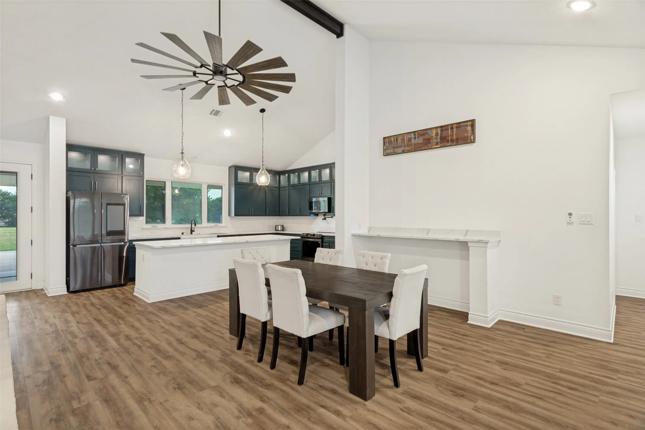 Dining area with built in serving bar and view into kitchen