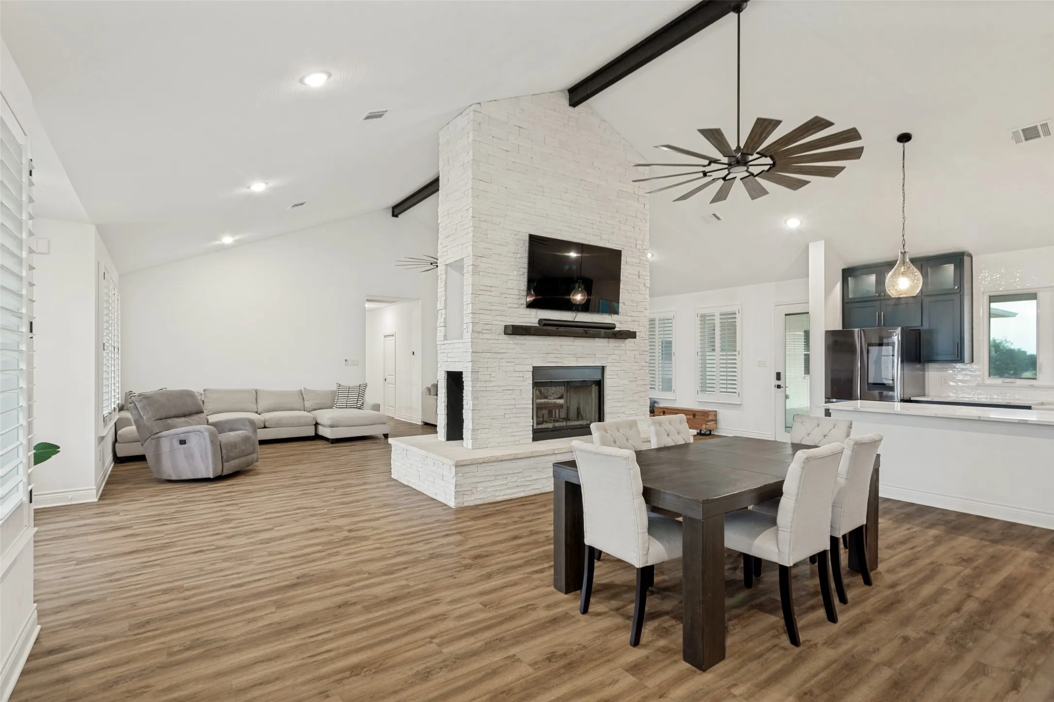 Dining and living areas showing open concept and flow into the kitchen
