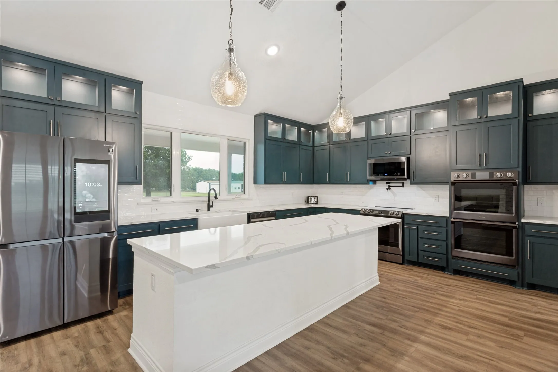 Fantastic chef’s dream kitchen with a 12’ island with room for barstool seating and cabinet storage.  Numerous cabinets for all storage needs and beautiful quartz counter space. There is a full suite of high end appliances (including 3 ovens!) and the stainless refrigerator will remain with the​​‌​​​​‌​​‌‌​‌‌​​​‌‌​‌​‌​‌​​​‌​​ property