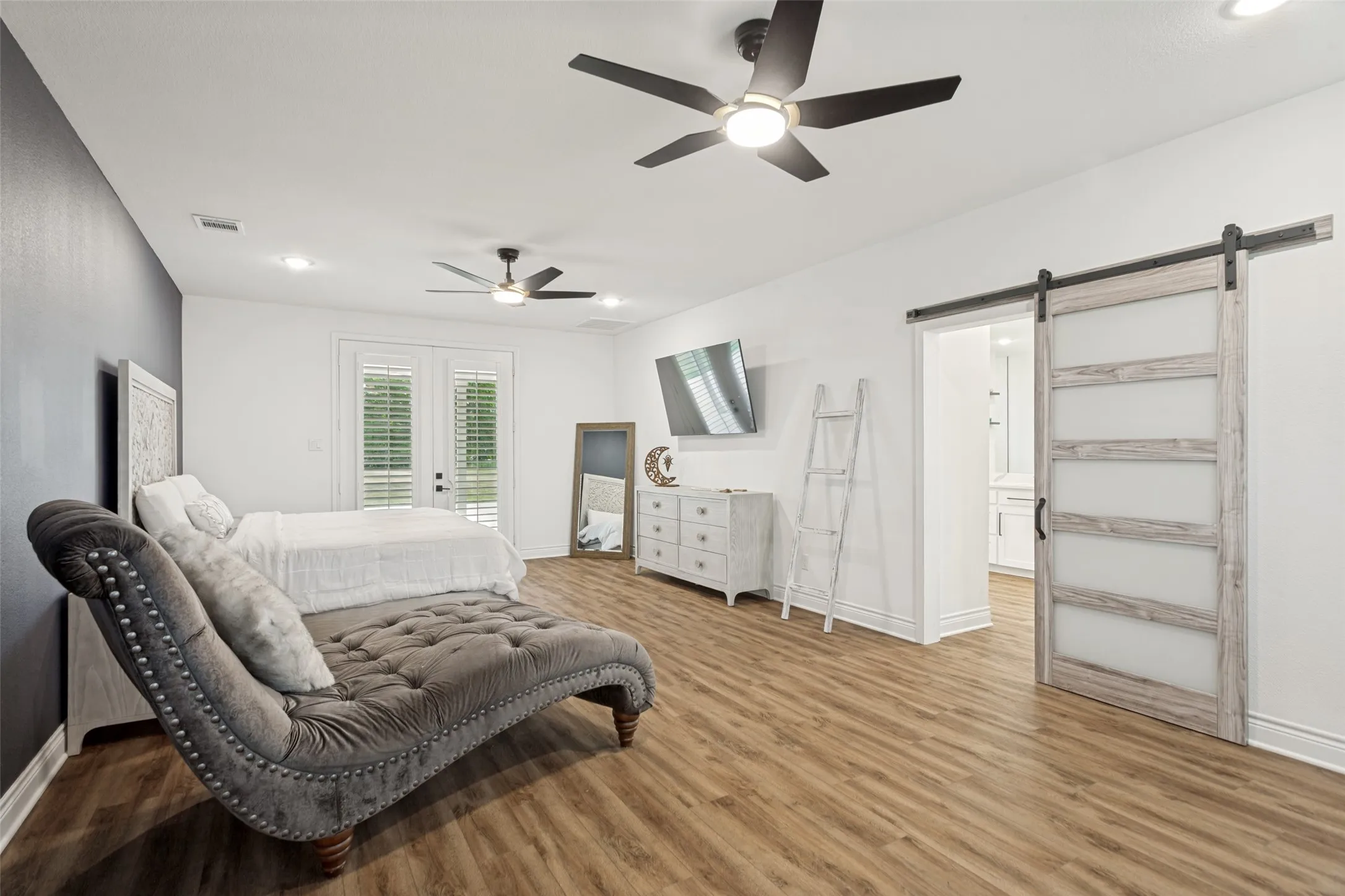 Very spacious 28’ x 15’ secluded owner’s retreat with access to the patio through double doors and a wall of built in cabinets and window seat
