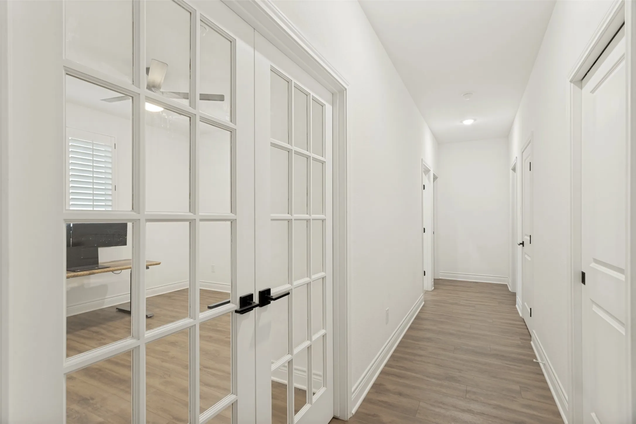Hallway showing double doors to office or fourth bedroom