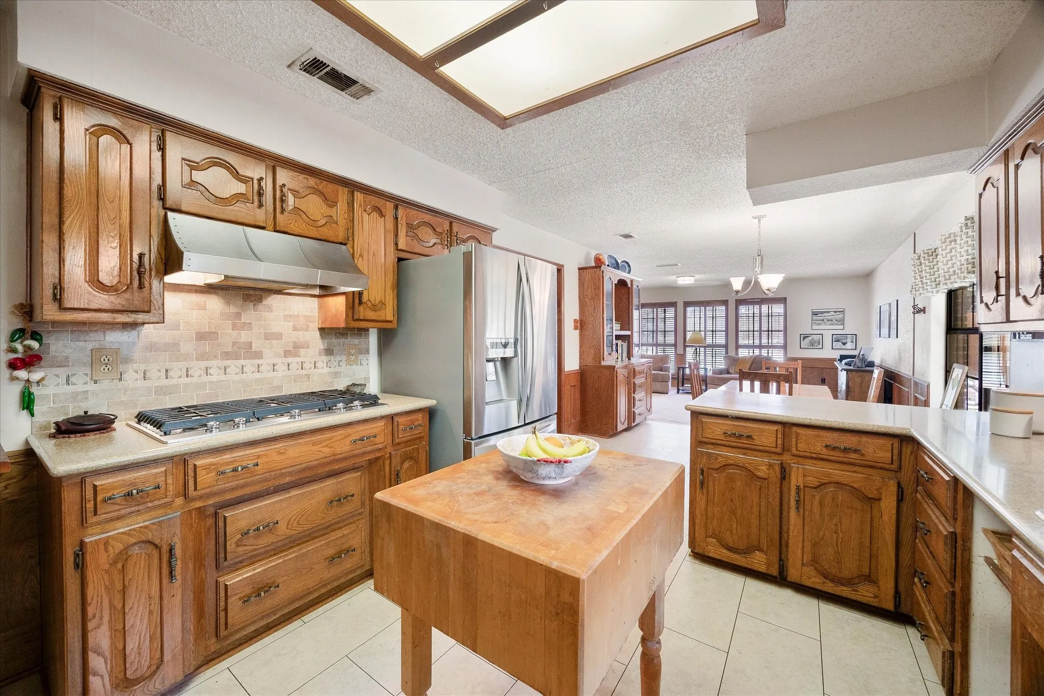 Fabulous gas cooktop, tons of custom cabinetry, breakfast bar and ample countertops will please your chef!