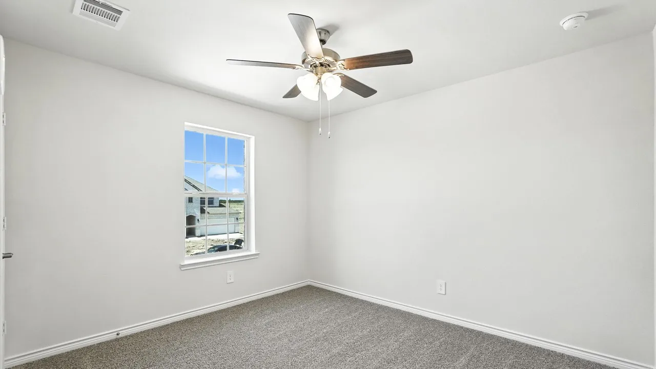 Room featuring light gray carpet, white walls, and a ceiling fan with light kit
