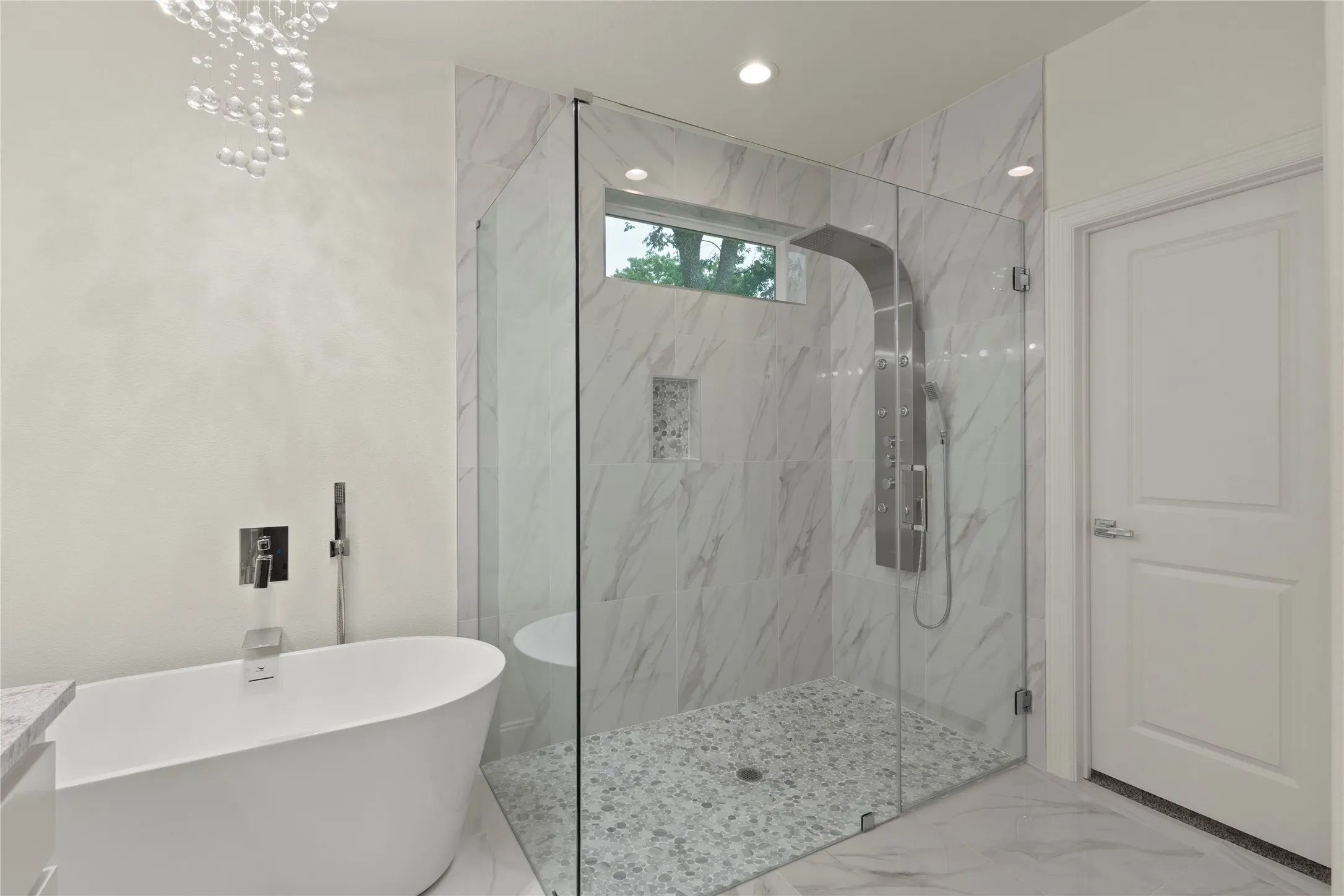 Freestanding soaking tub with floor-mounted faucet