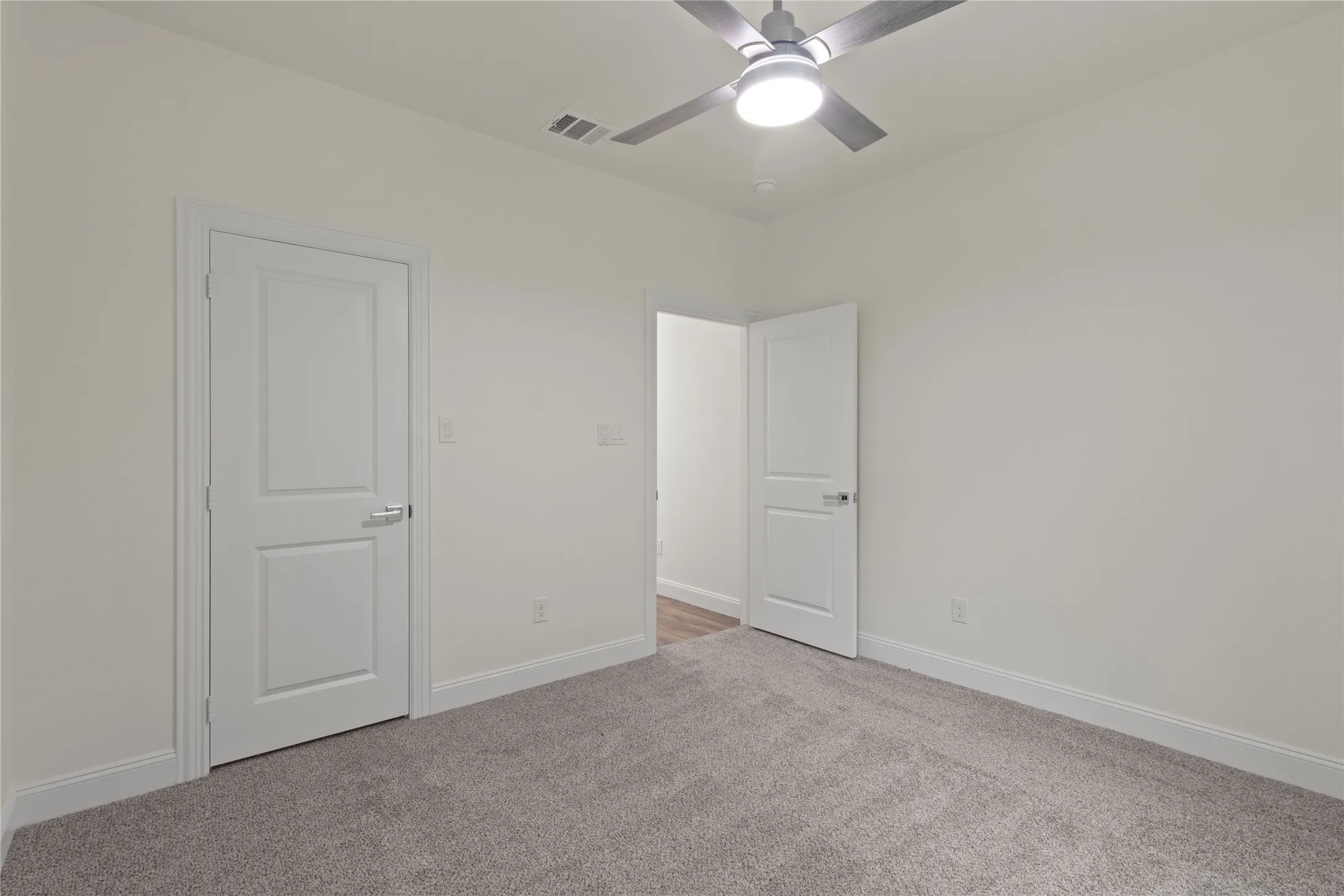 Room featuring light gray carpeting and white trim