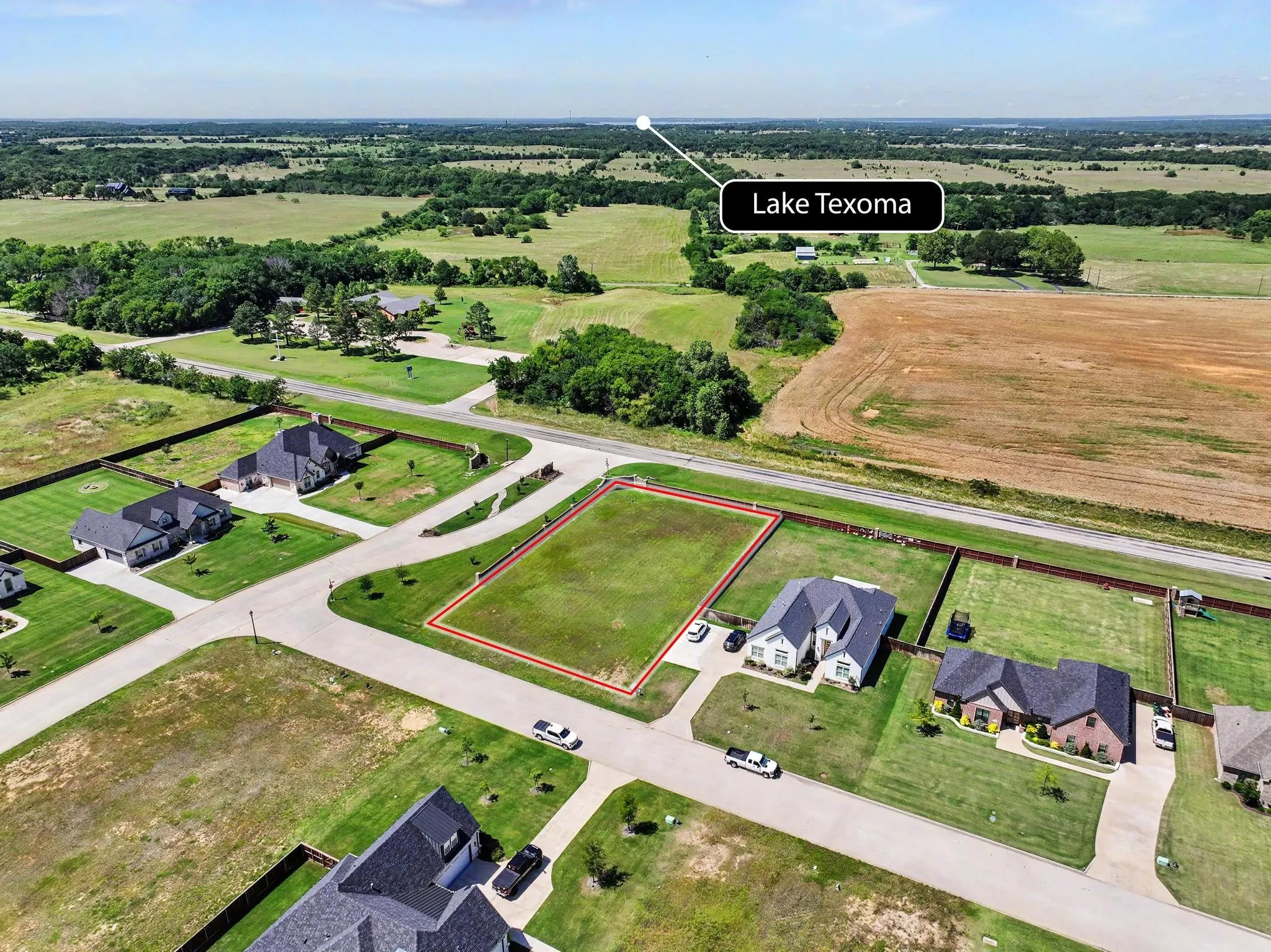 Cleared residential lot bordered by existing paved roads