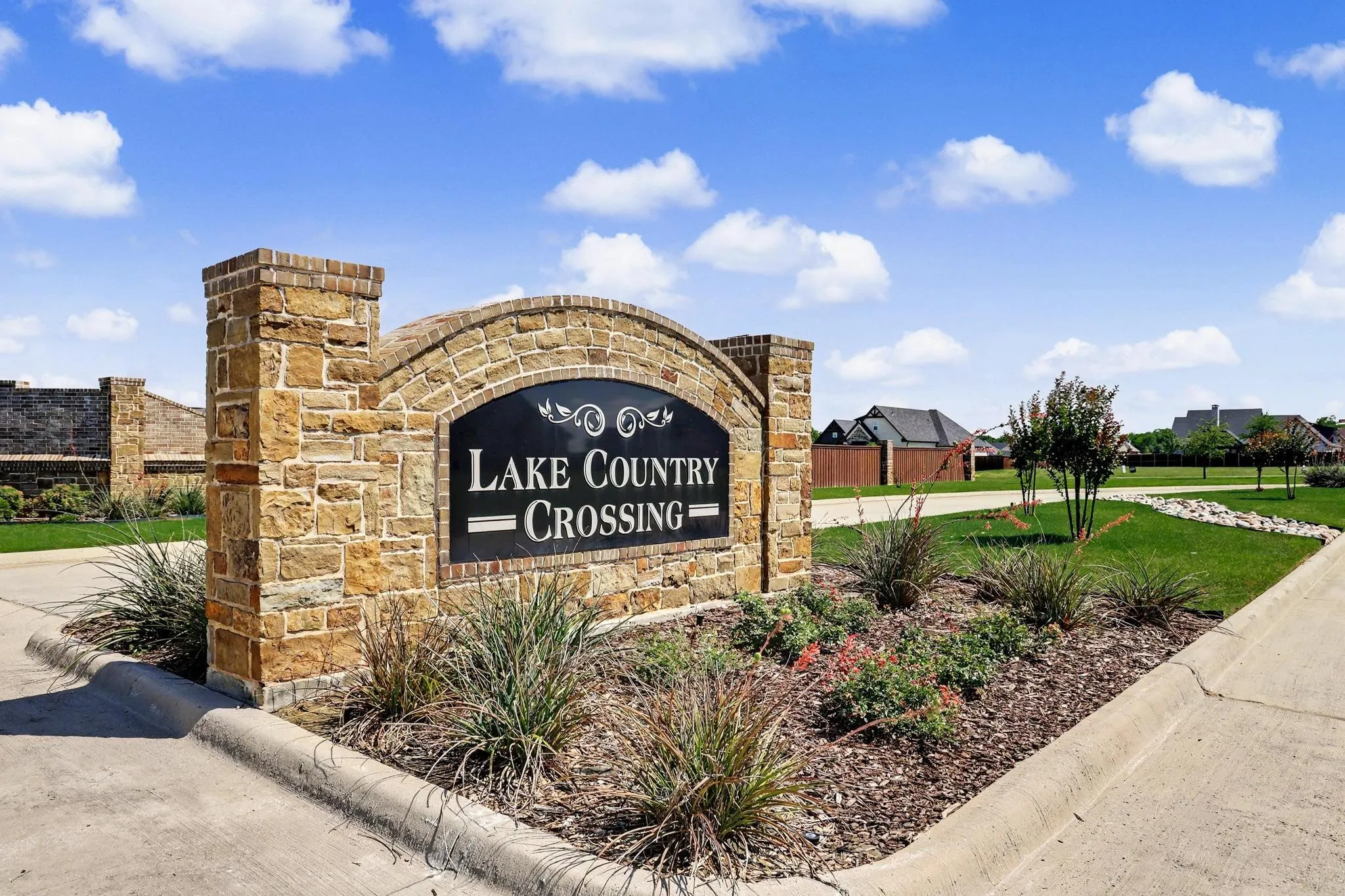 Stone and brick entry monument with integrated landscaping
