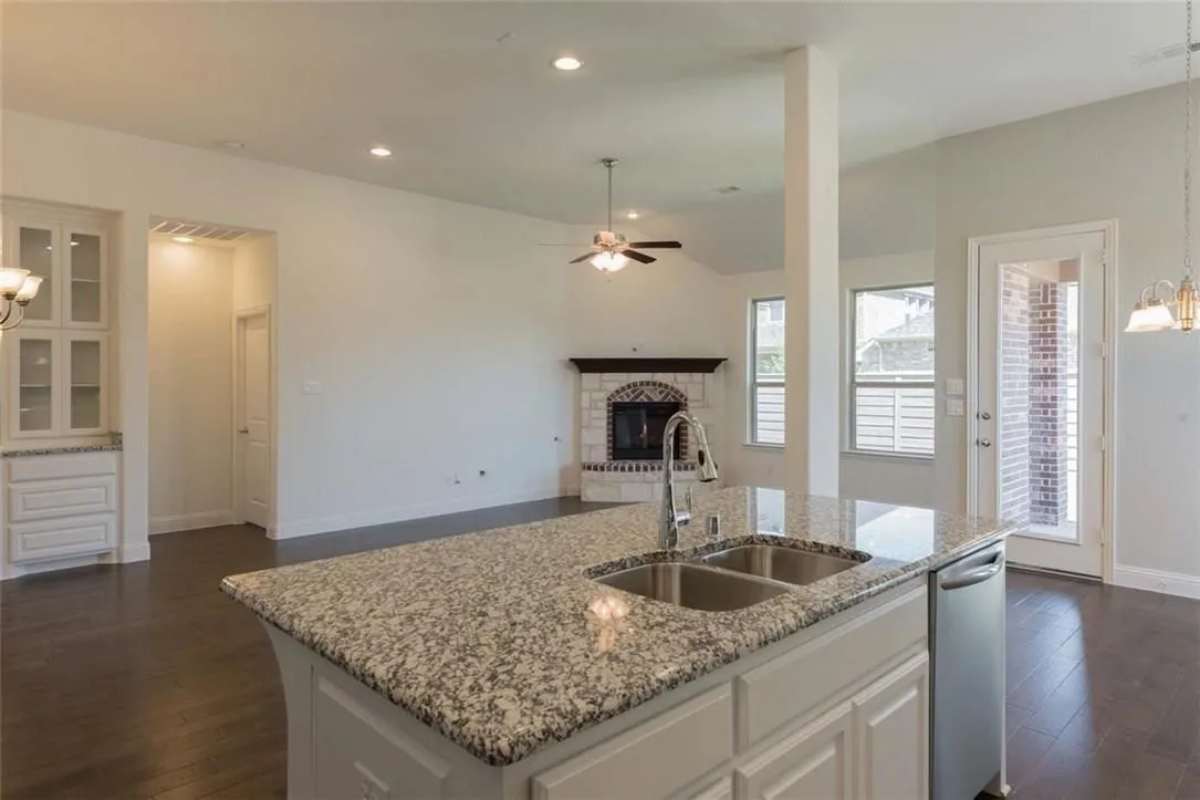 Kitchen island with granite countertop and double stainless steel sink