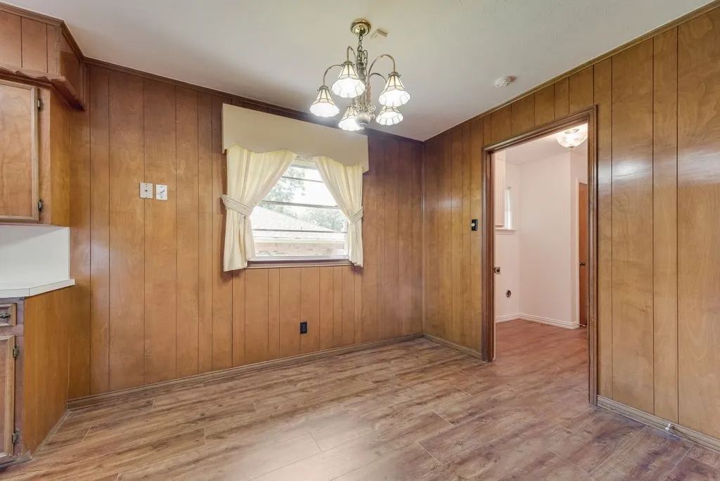 Interior room featuring wood-finish paneling and wood-finish flooring