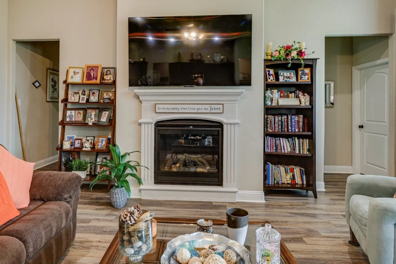 Central fireplace with a decorative mantel and hearth, flanked by two archways