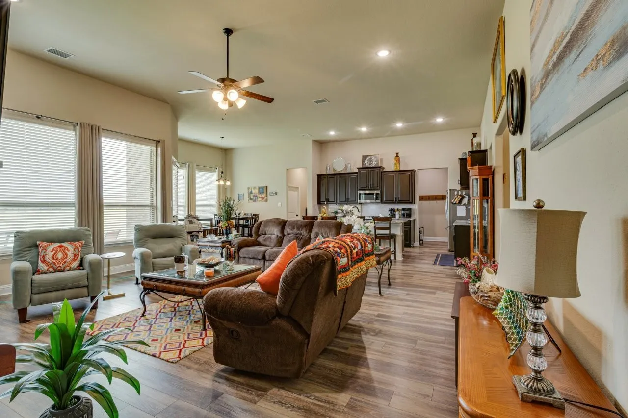 Open-concept living area featuring wood-finish flooring, recessed lighting, and a ceiling fan