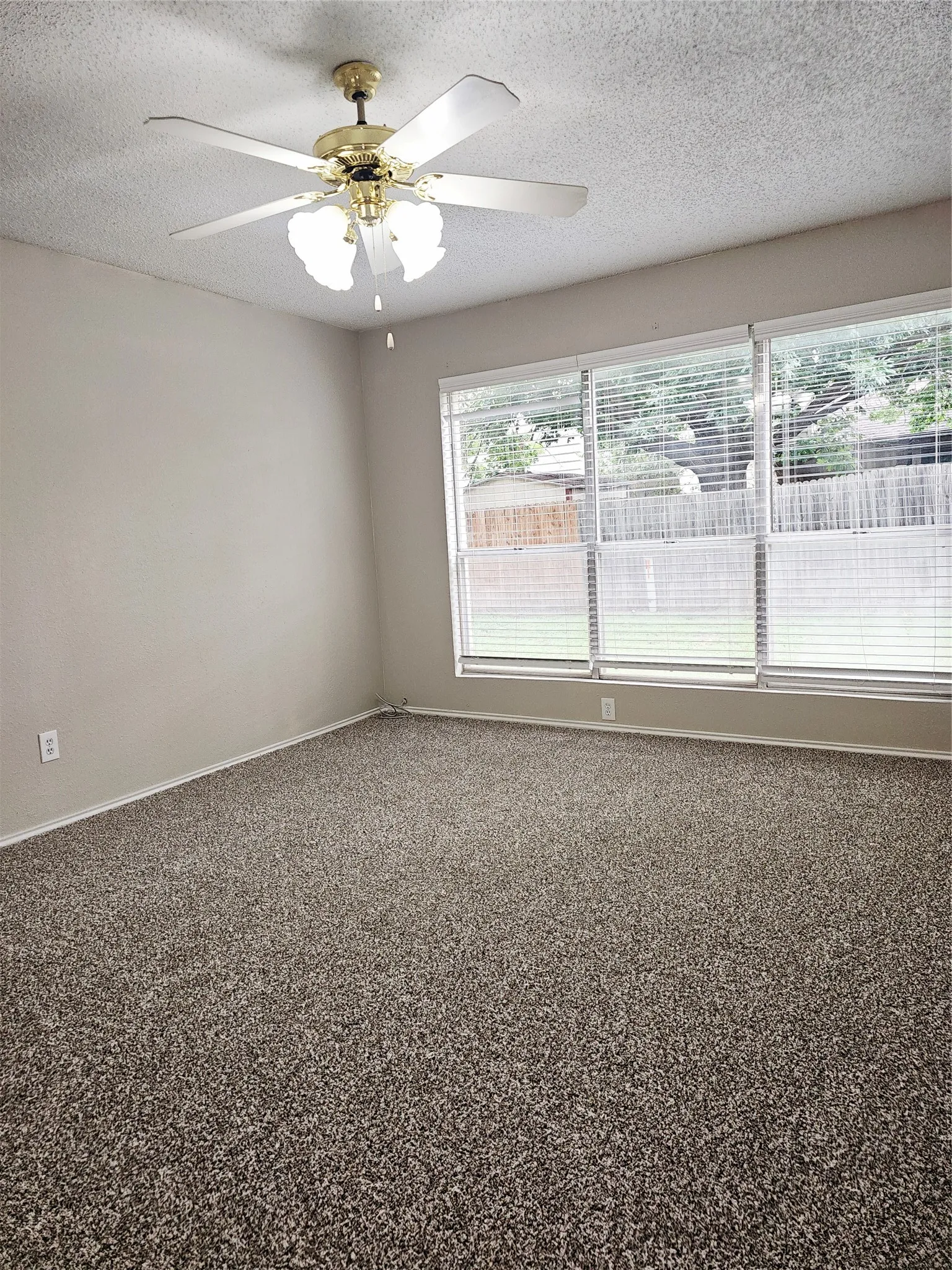 Spacious room featuring neutral carpeting and light-toned walls