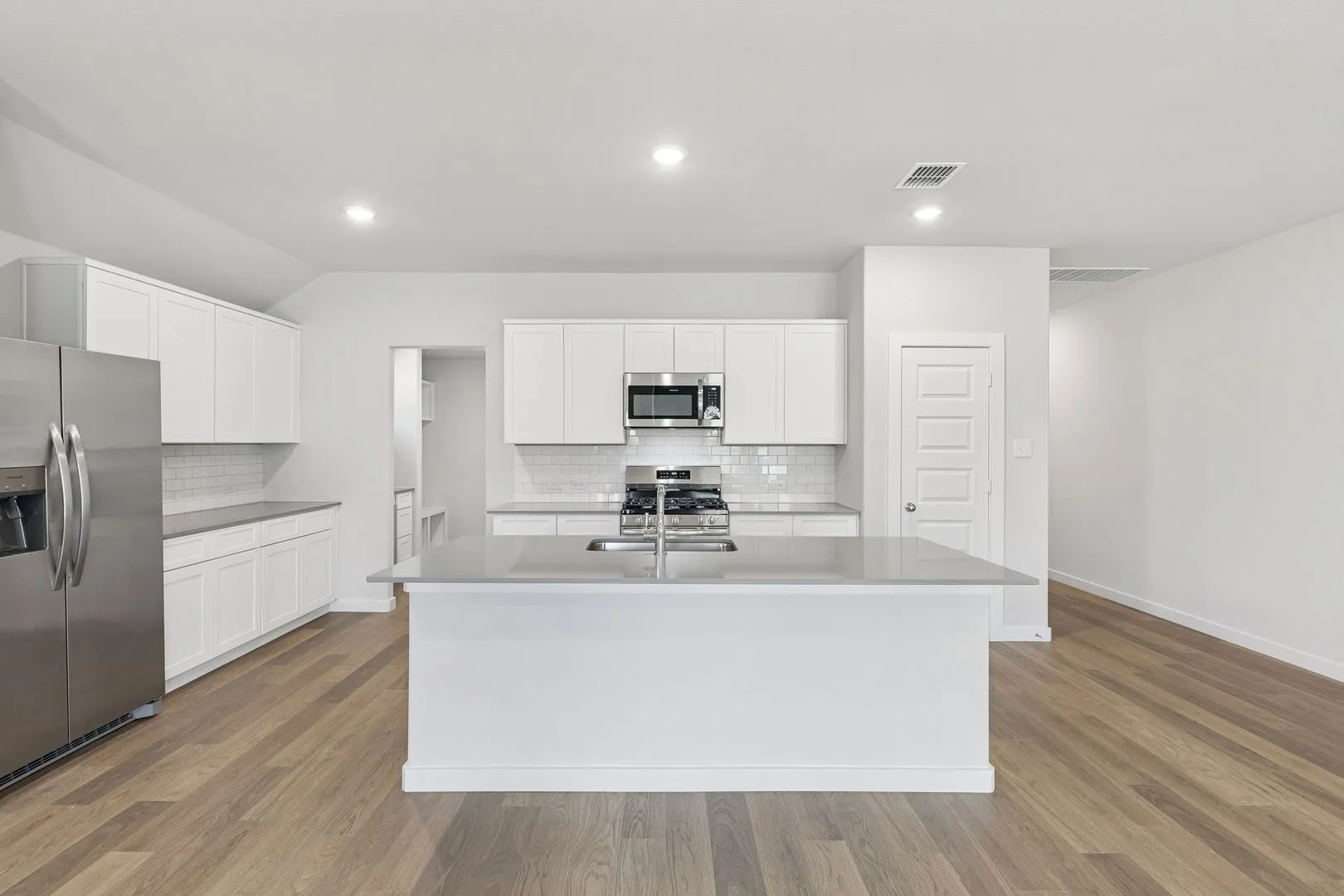 Kitchen in the Harrison home plan by Trophy Signature Homes – REPRESENTATIVE PHOTO