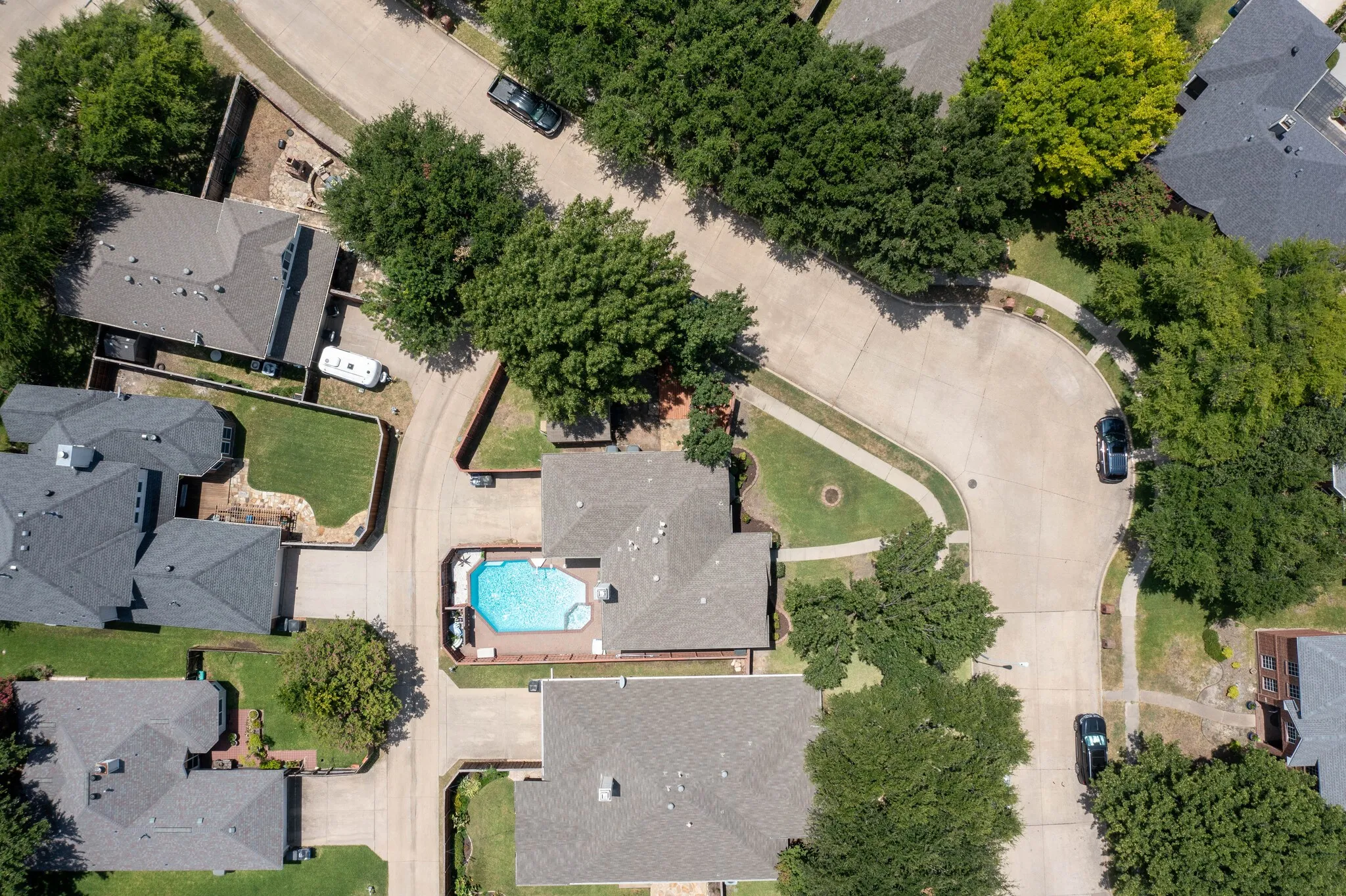 Aerial perspective showcasing a residential property with a private swimming pool