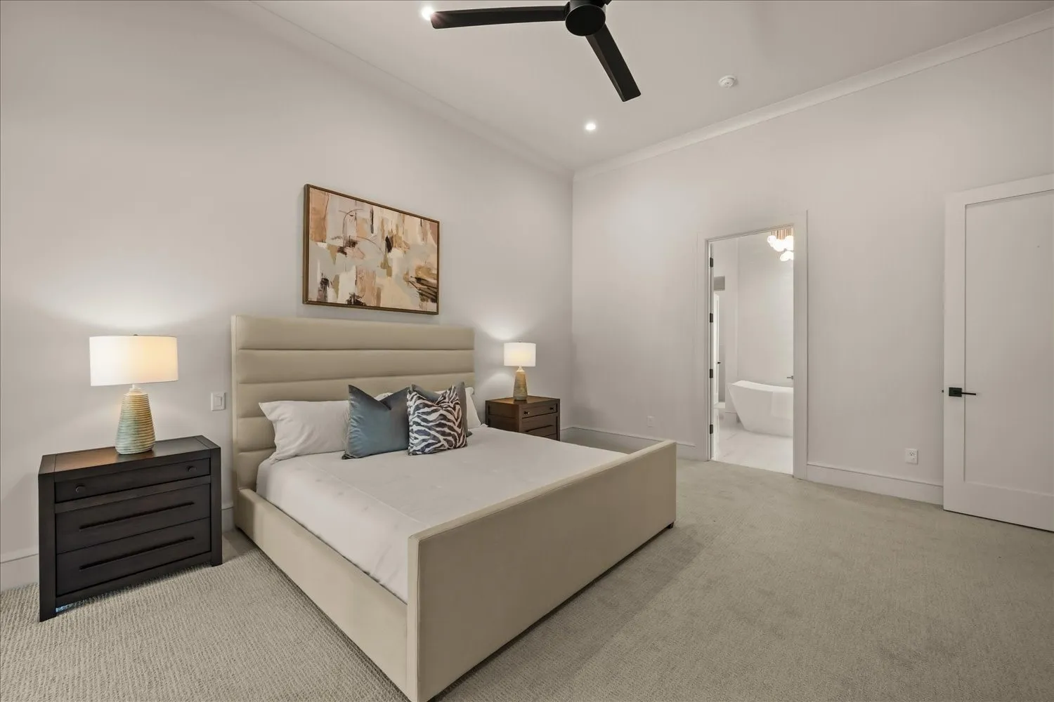 Recessed lighting throughout, crown molding, ceiling fan, carpet flooring, and a flat-panel interior door with matte black hardware