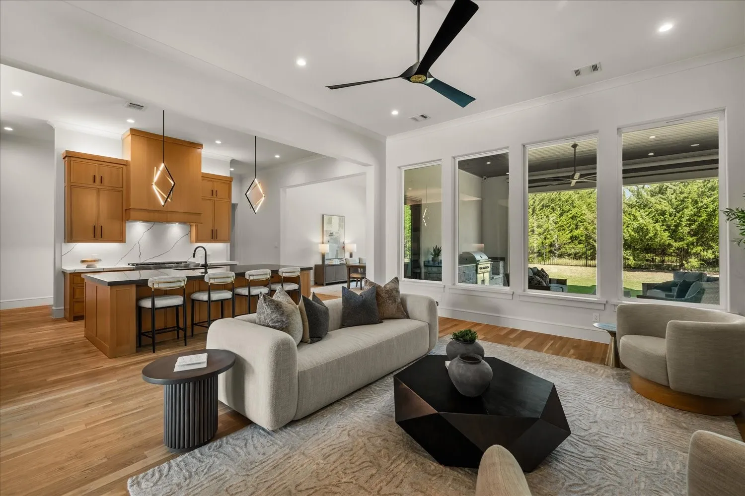 Hardwood flooring throughout, recessed lighting, and a contemporary ceiling fan