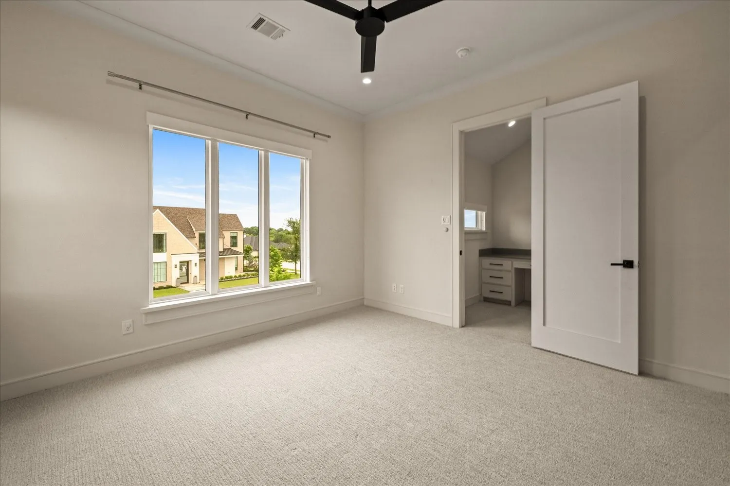 Spacious room with a triple window offering abundant natural light
