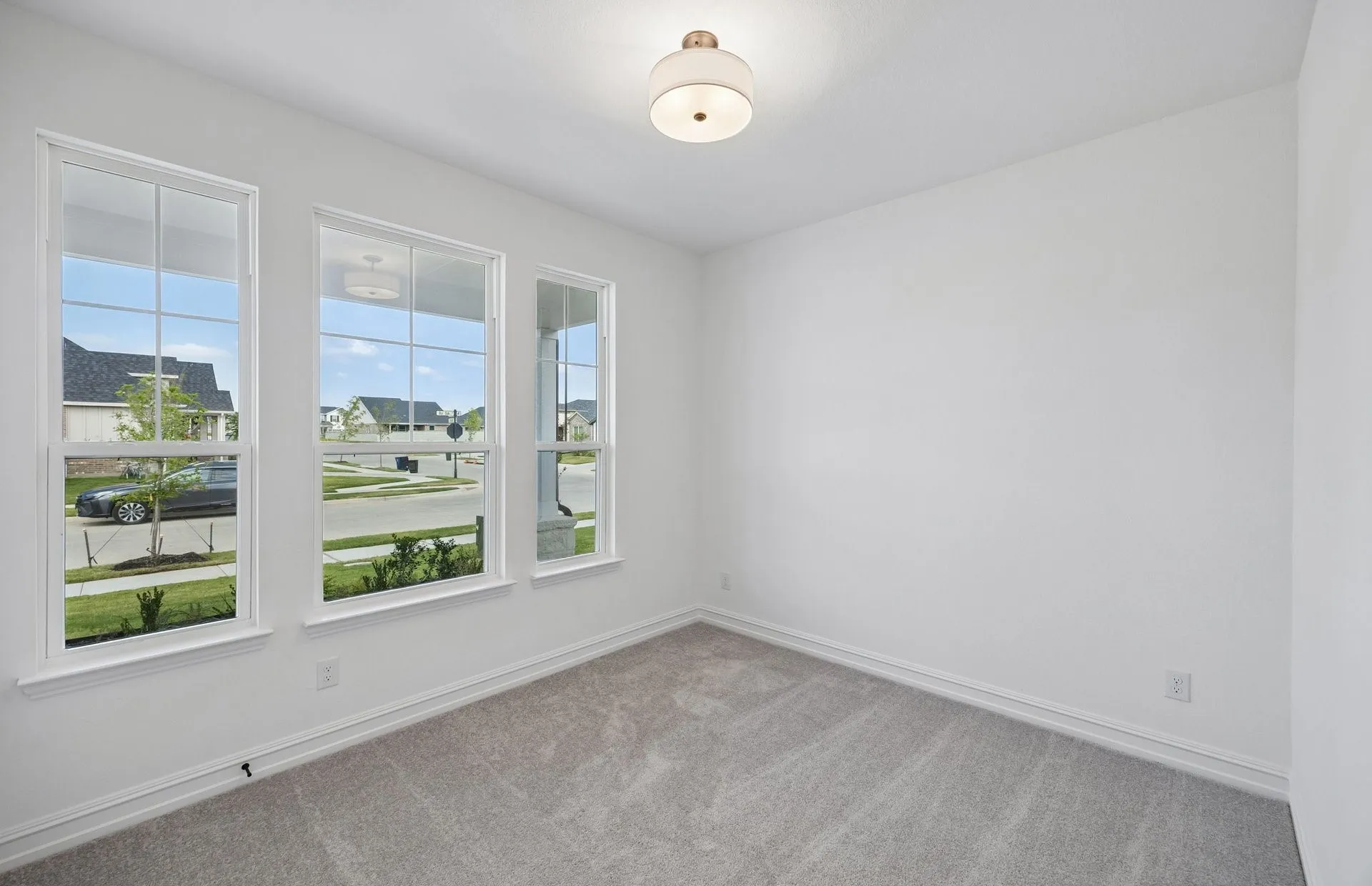 Secondary bedroom with large windows on first level