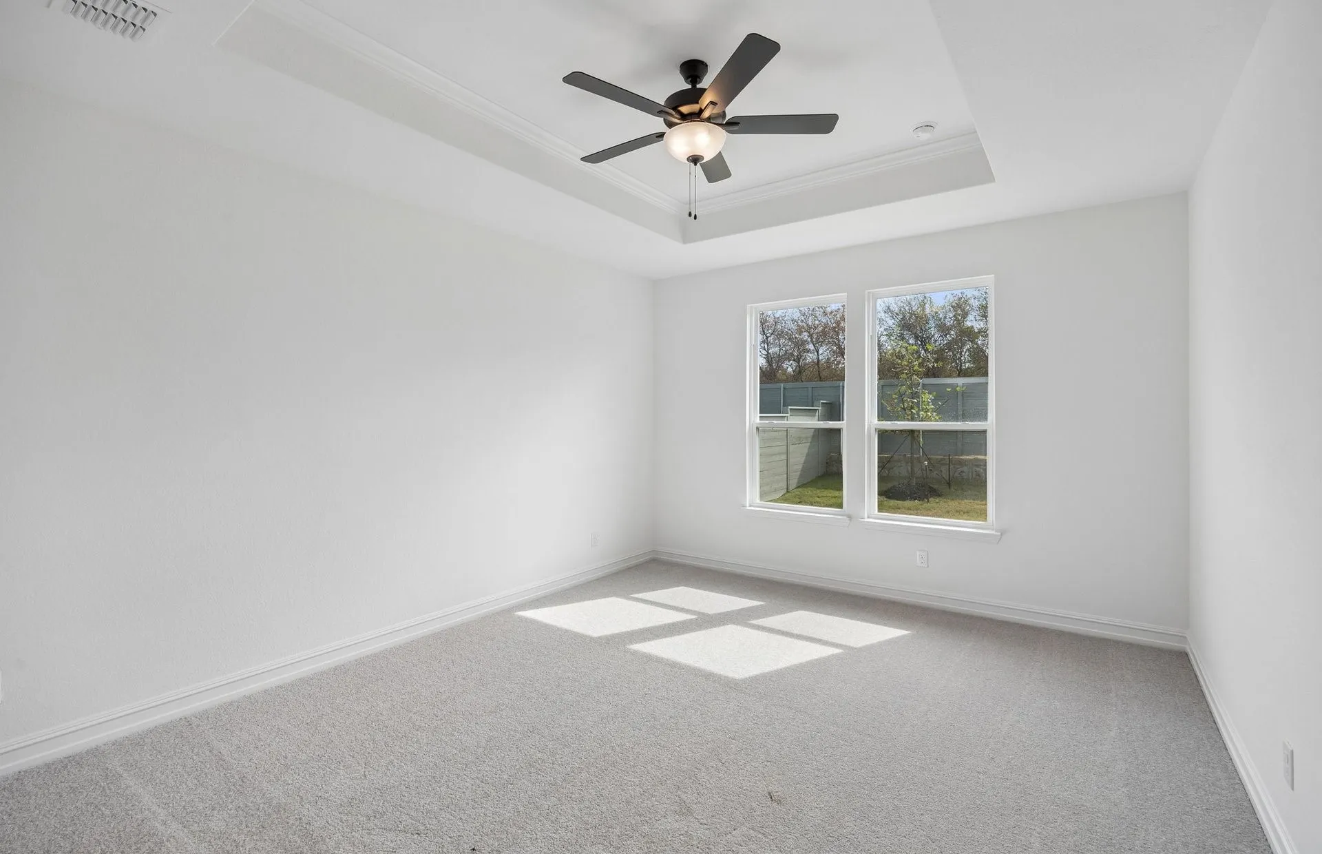 Tray ceiling in primary bedroom