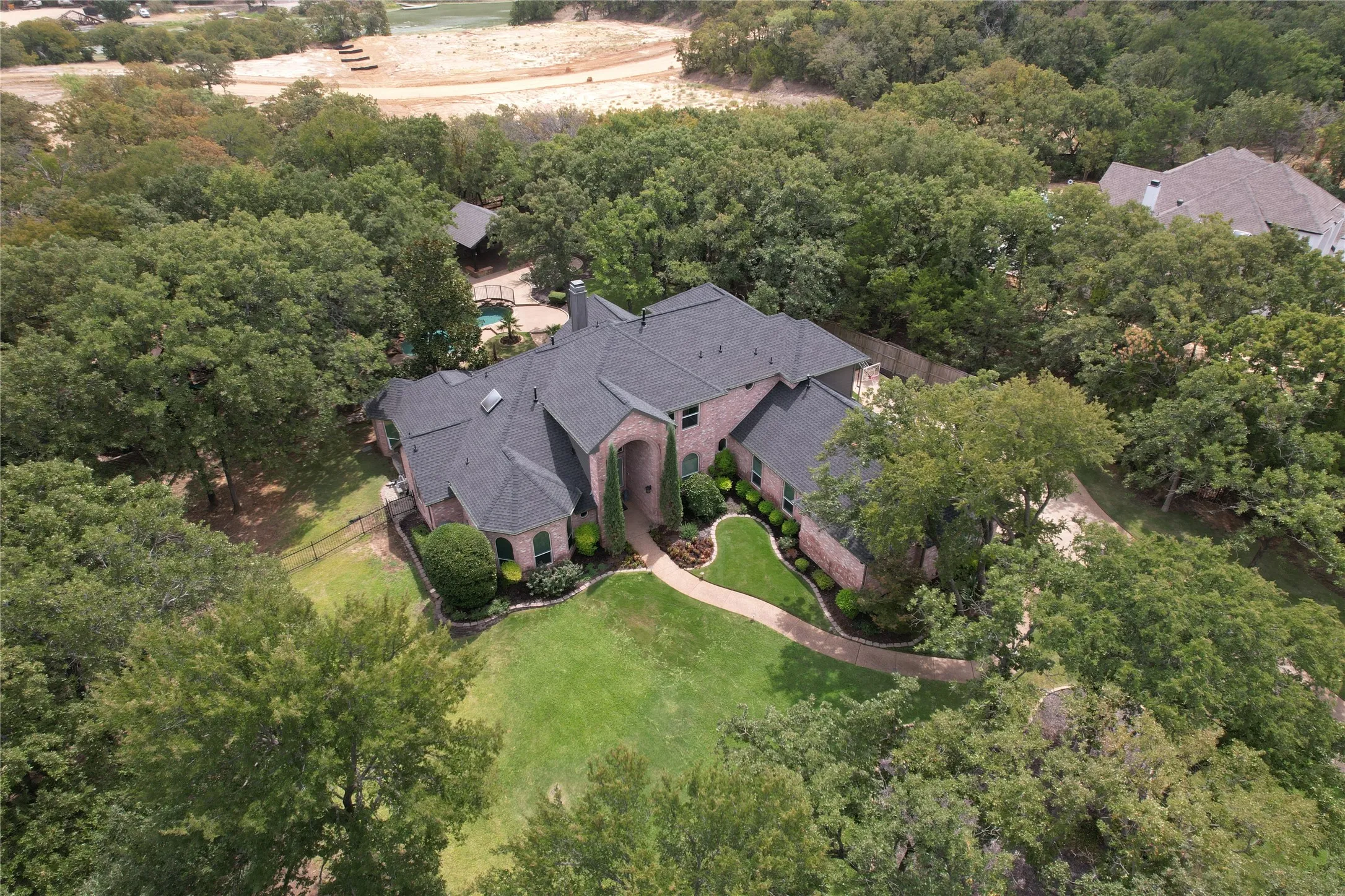 Brick exterior with dark shingle roofing