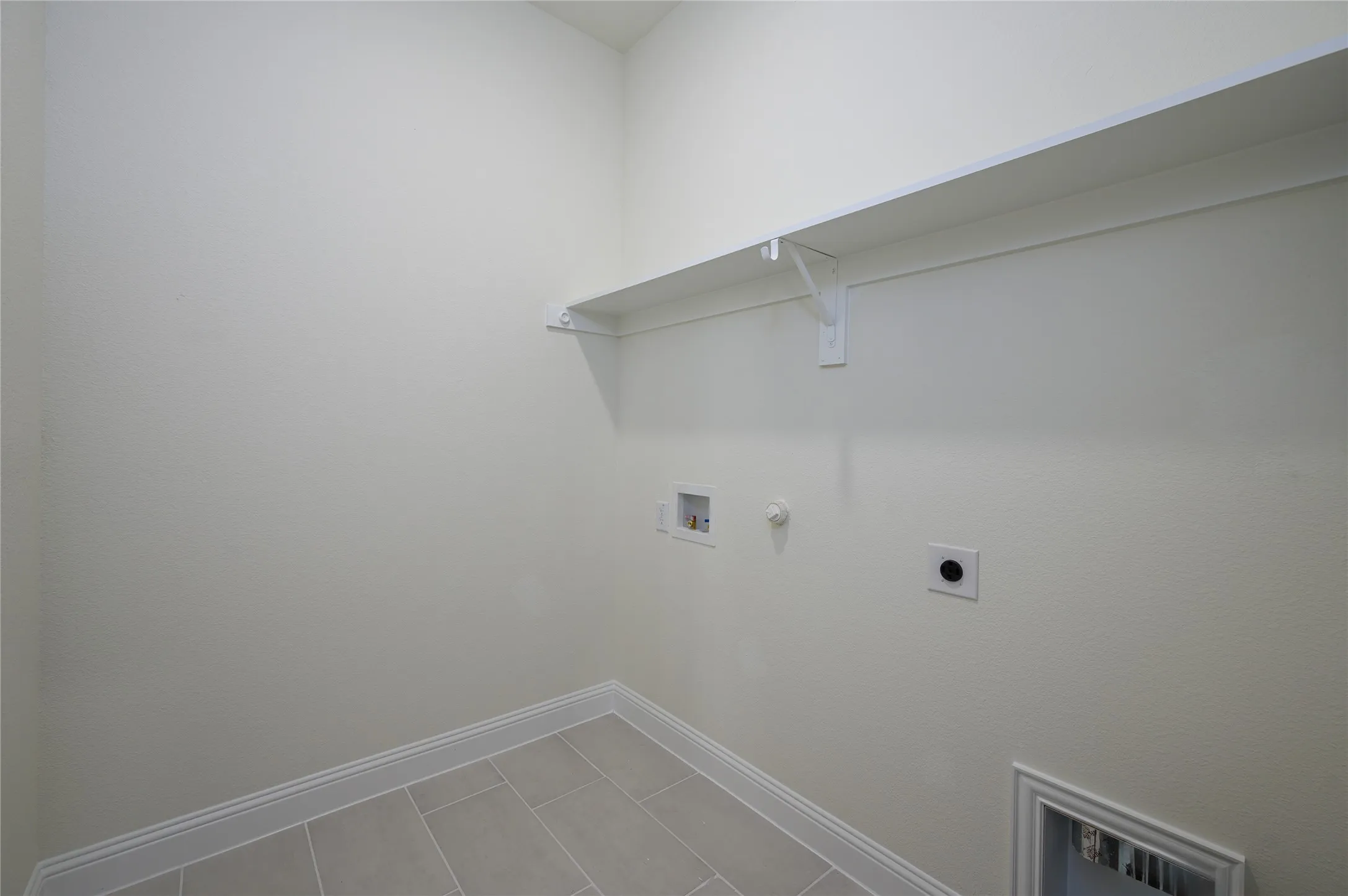 Washroom featuring tile patterned floors, electric dryer hookup, washer hookup, and hookup for a gas dryer