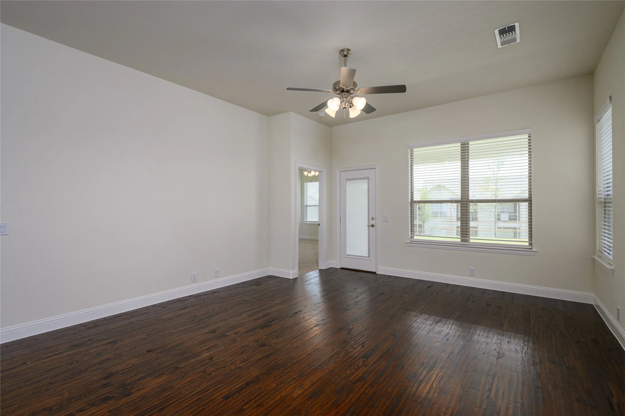 Family room featuring hand scraped flooring and ceiling fan