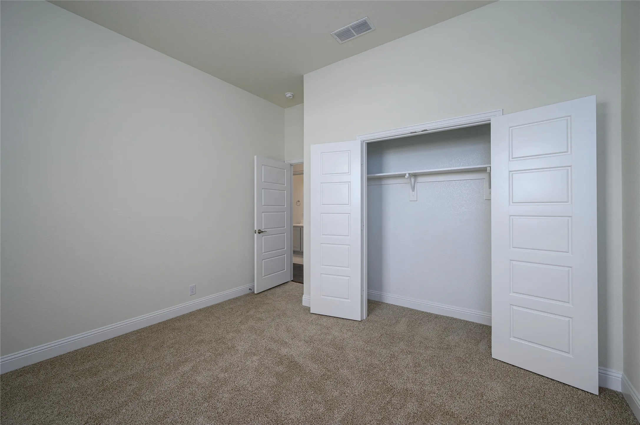 Unfurnished bedroom featuring carpet and a closet