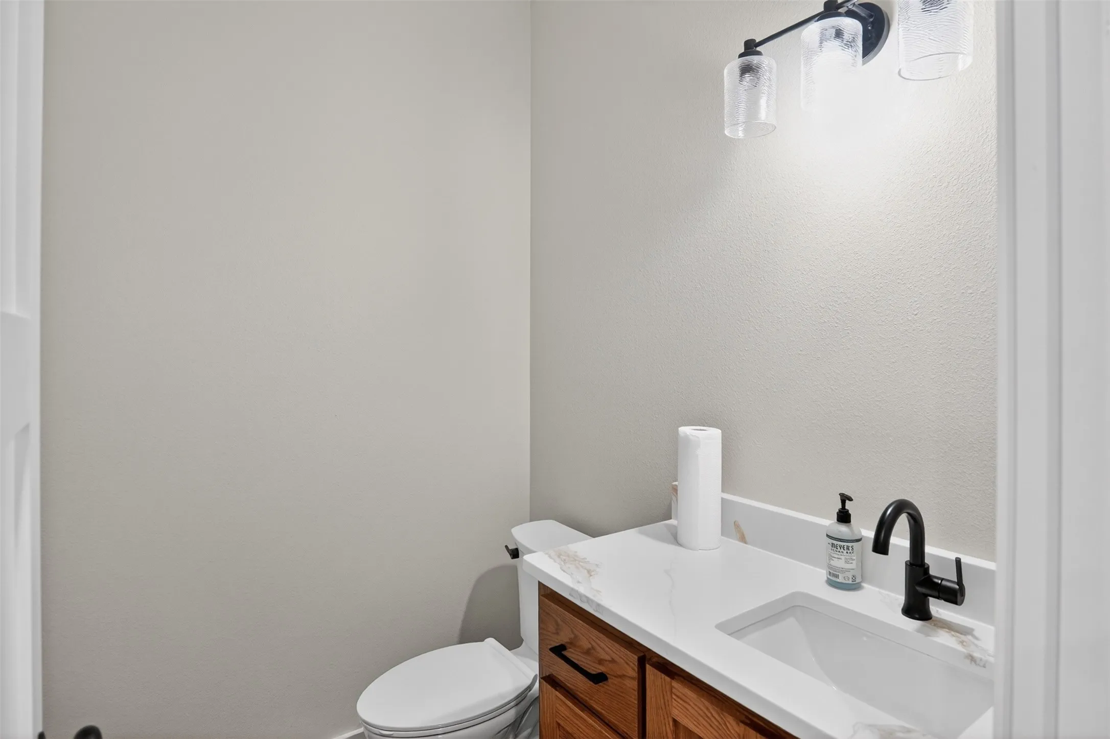 Half Bathroom vanity featuring a rectangular undermount sink and a white countertop