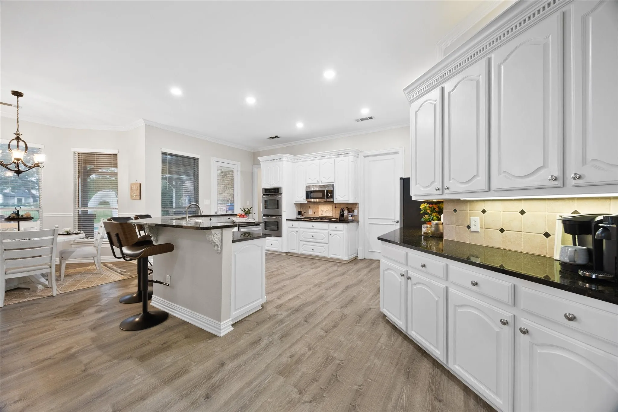 Open floor plan features dream kitchen overlooking breakfast area and family room