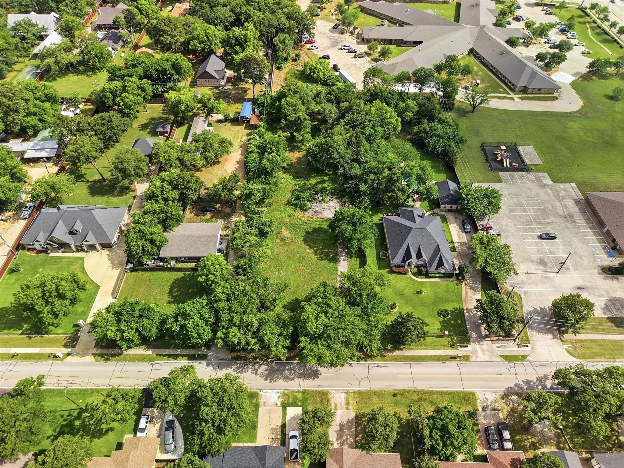 Aerial perspective showcasing property along with clear view of custom homes surrounding lot