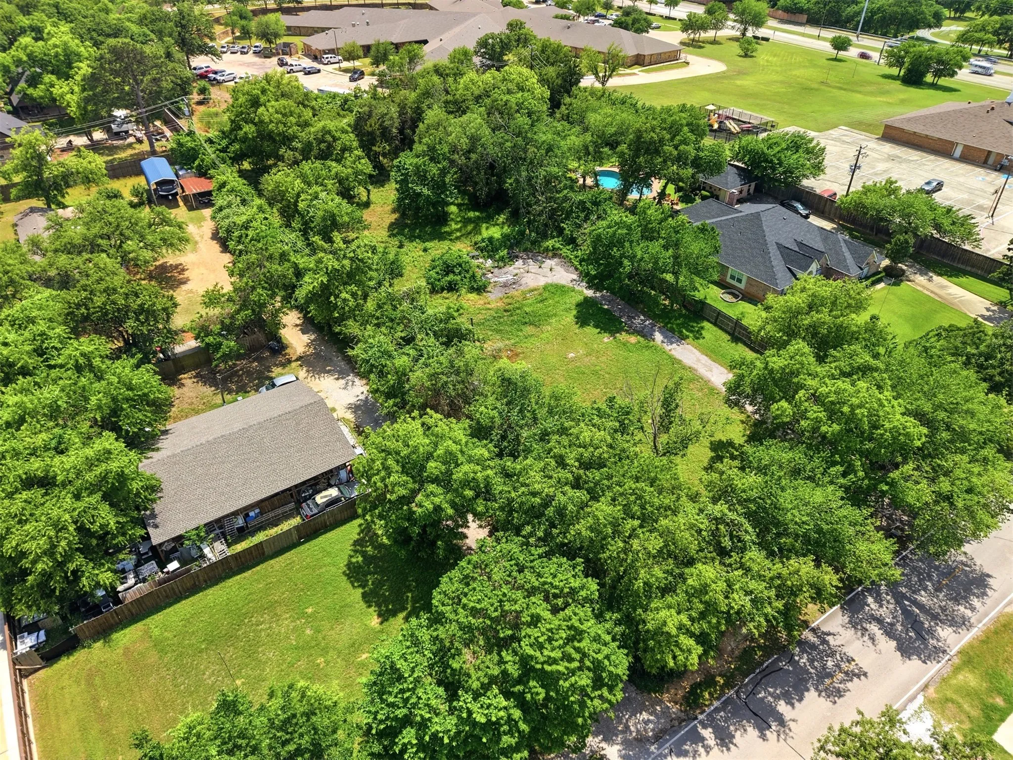 Another view of the property showcasing the existing driveway