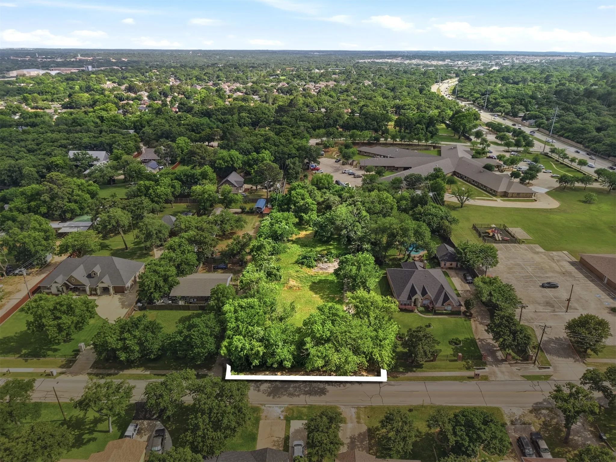 Aerial view of lot with custom homes around the property