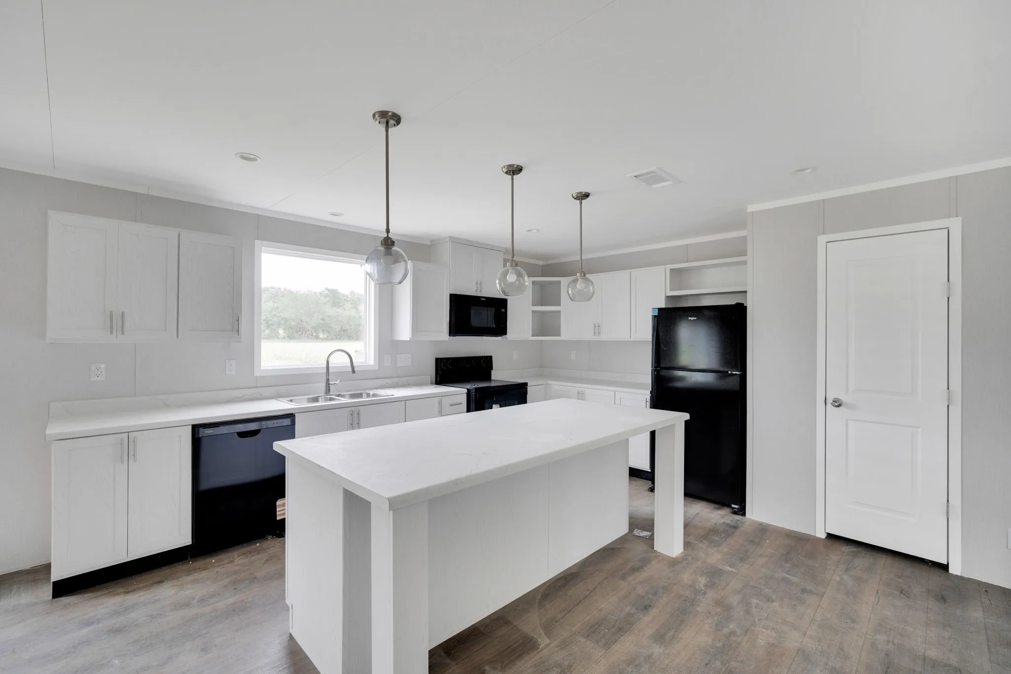 Open-concept kitchen with white cabinetry and an island