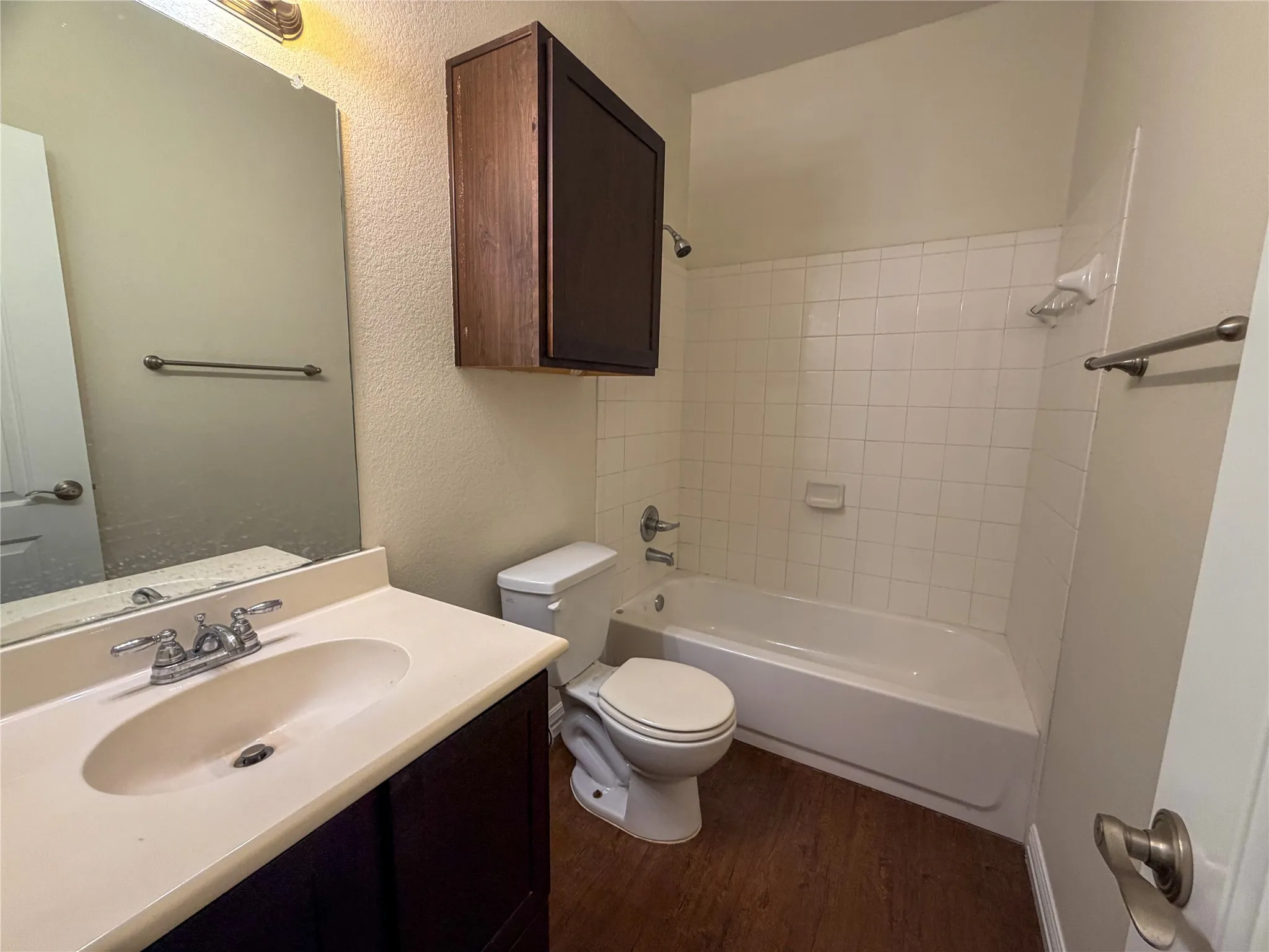 Bathroom 4: vanity featuring an integrated sink, polished chrome faucet, and dark wood-finish cabinetry