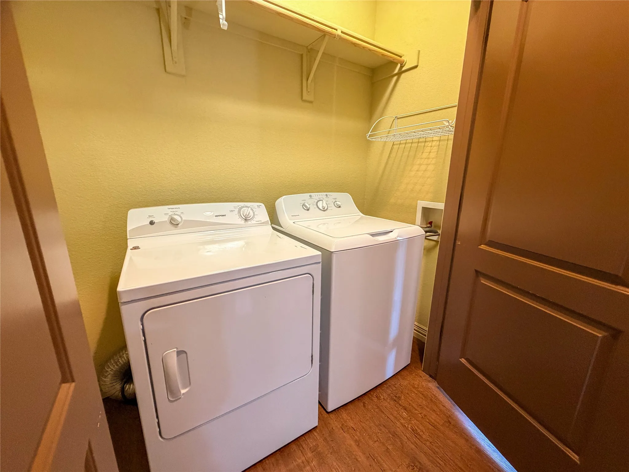 Dedicated laundry area featuring a white top-load washing machine and a white front-load dryer