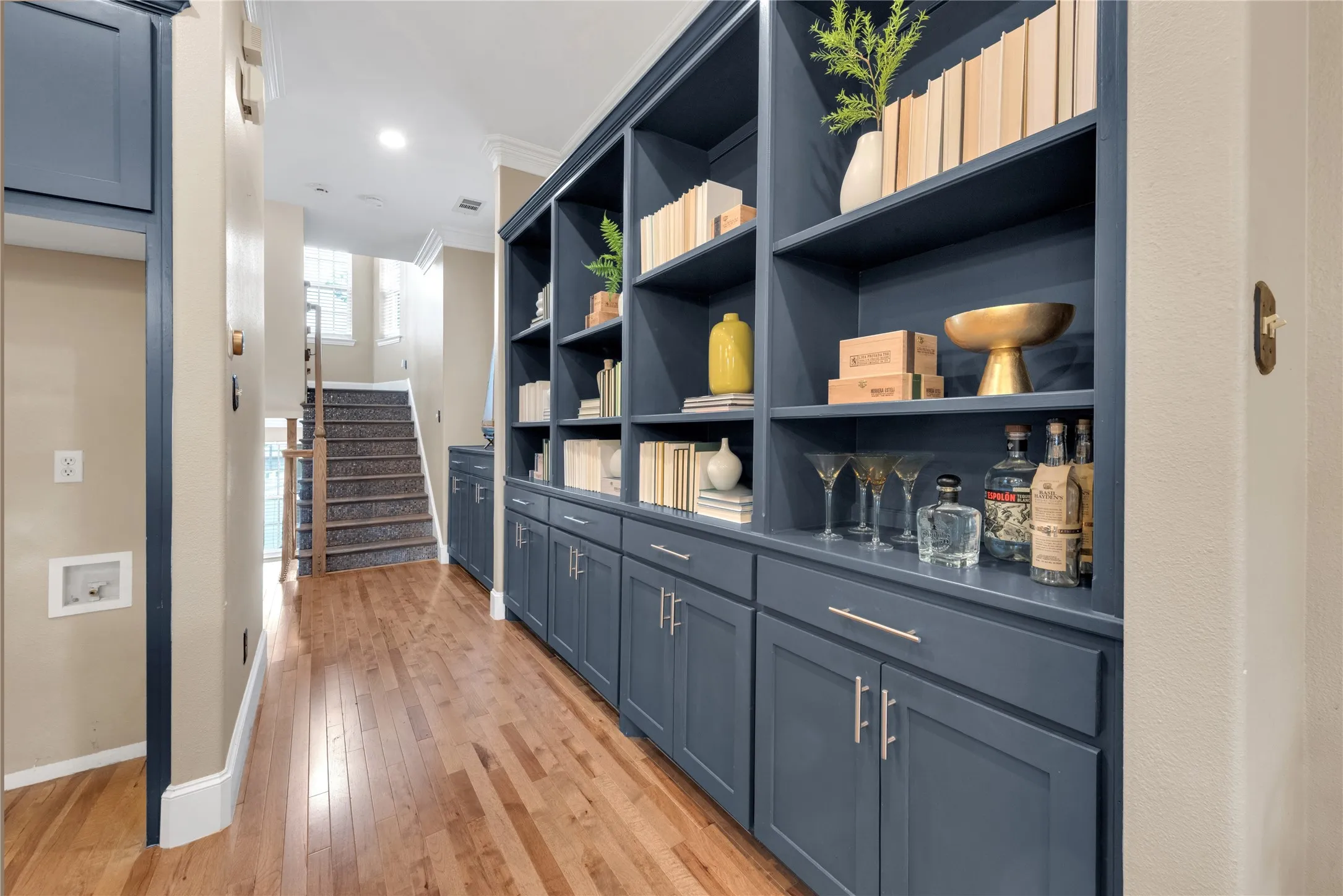 Custom built-in shelving with lower cabinetry and brushed nickel hardware