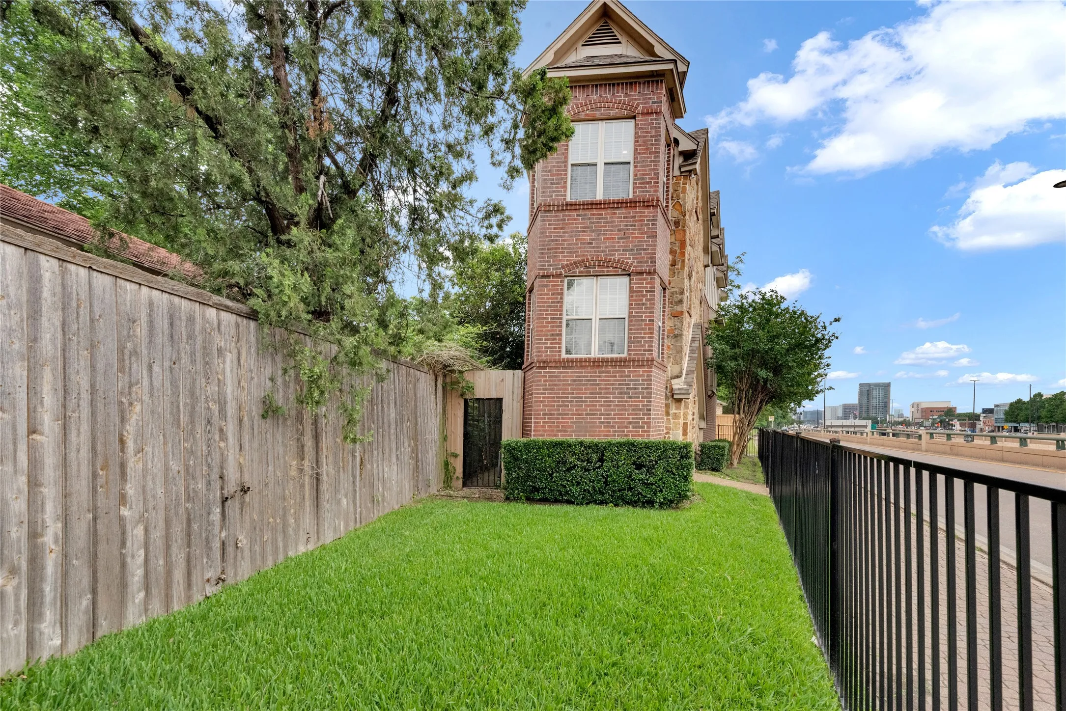 Brick exterior featuring multiple windows and architectural gables