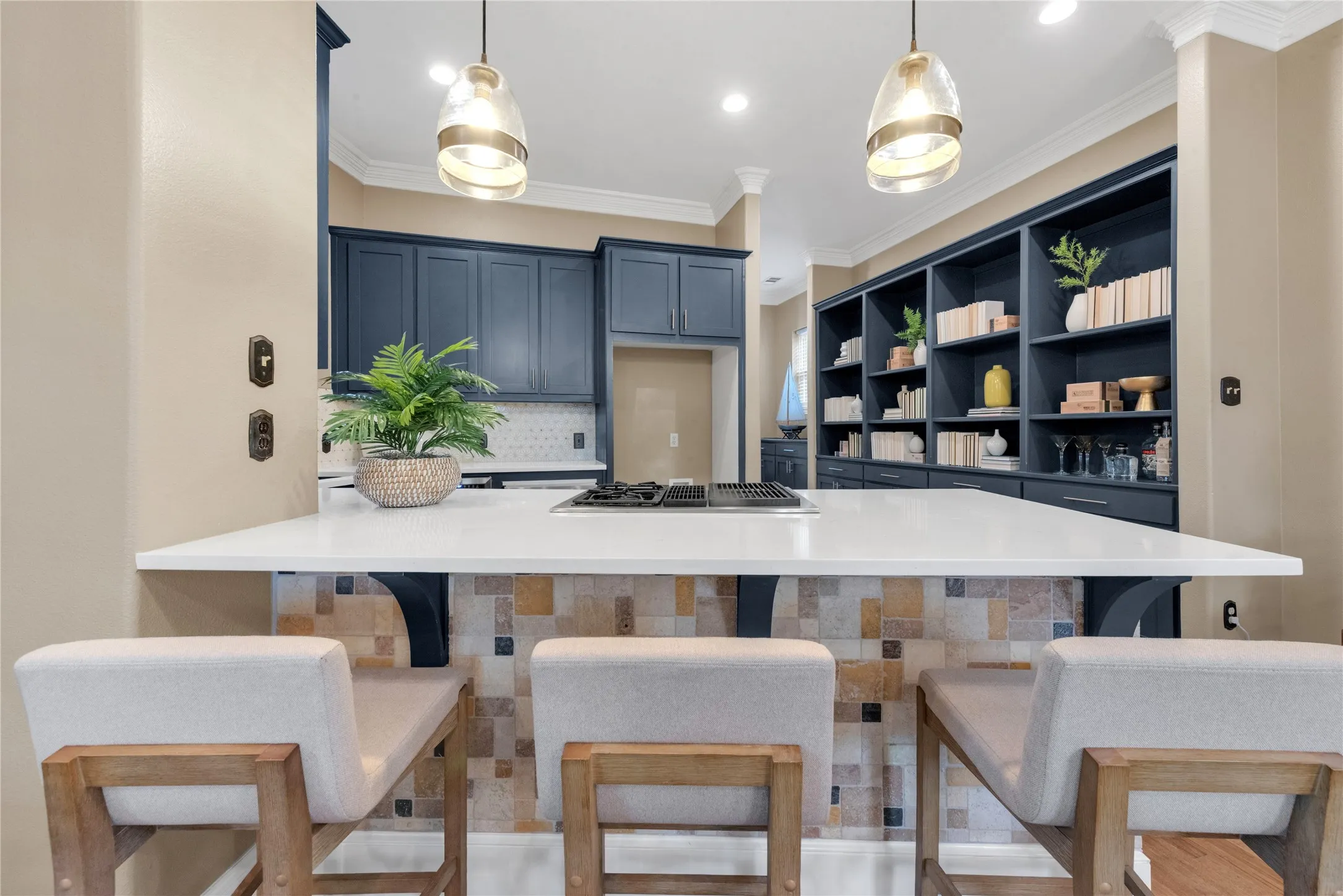 Kitchen island with a white countertop and integrated cooktop