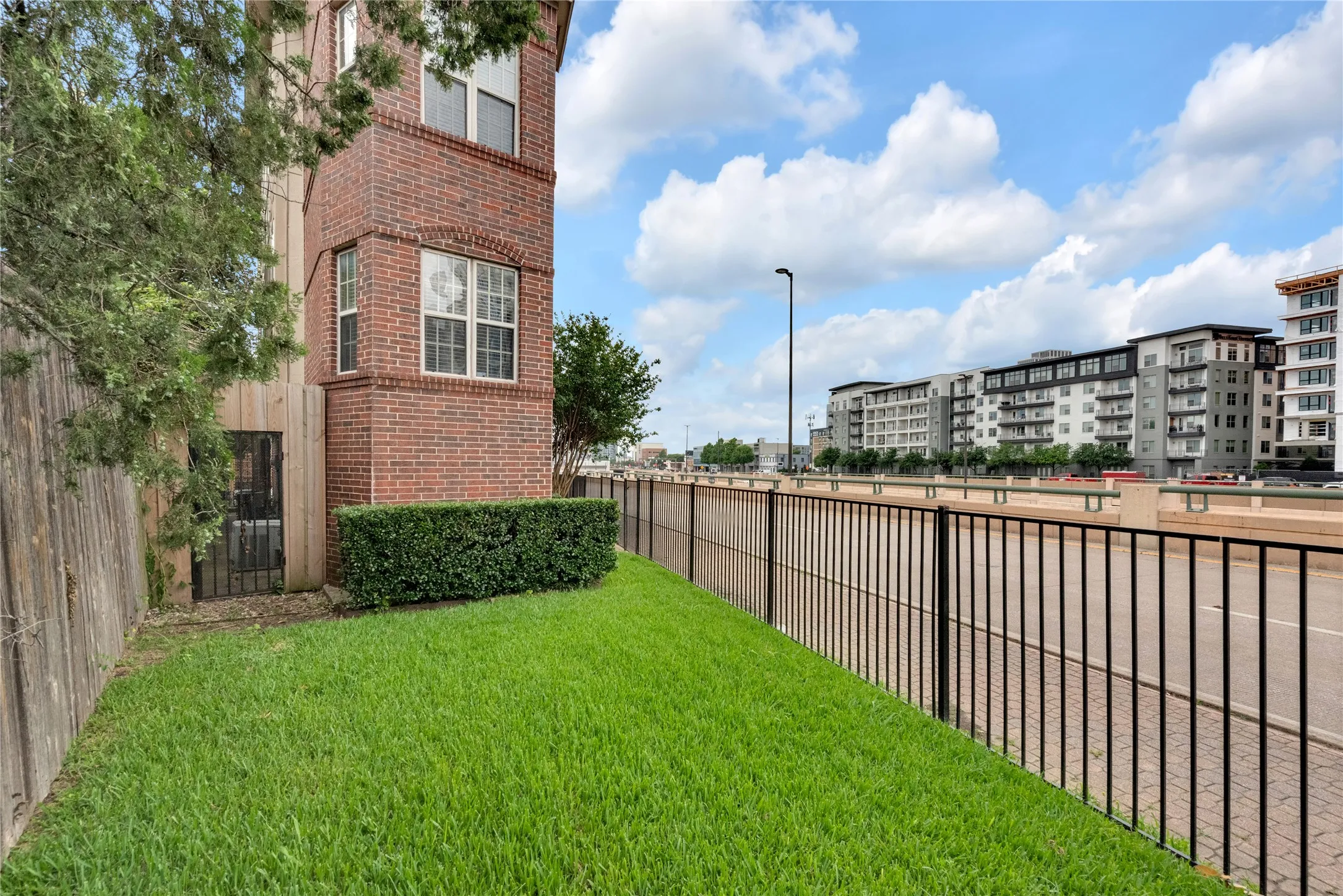 Brick exterior featuring multiple windows with arched detailing