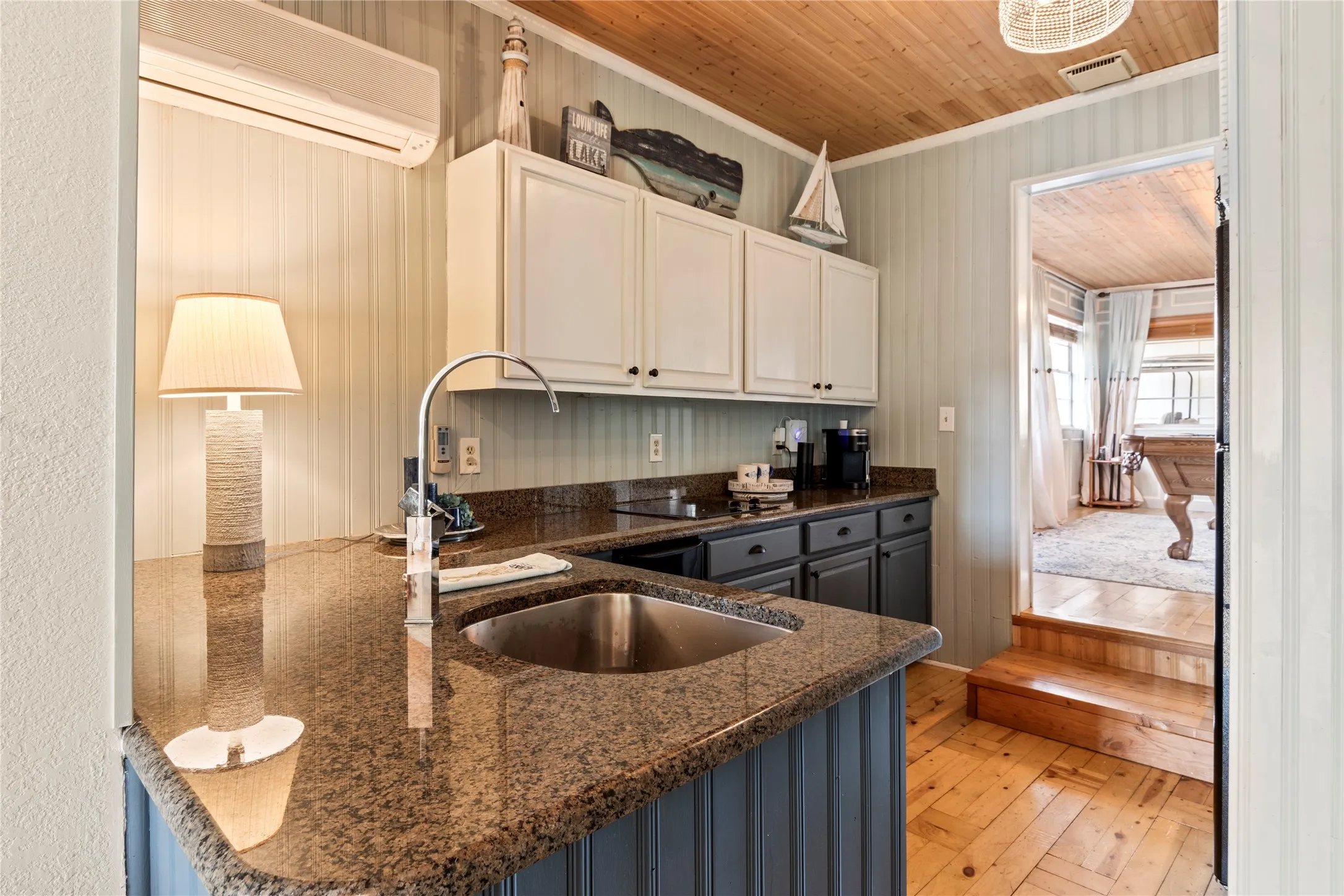Butler’s kitchen opening into the spacious game room and entertainment area