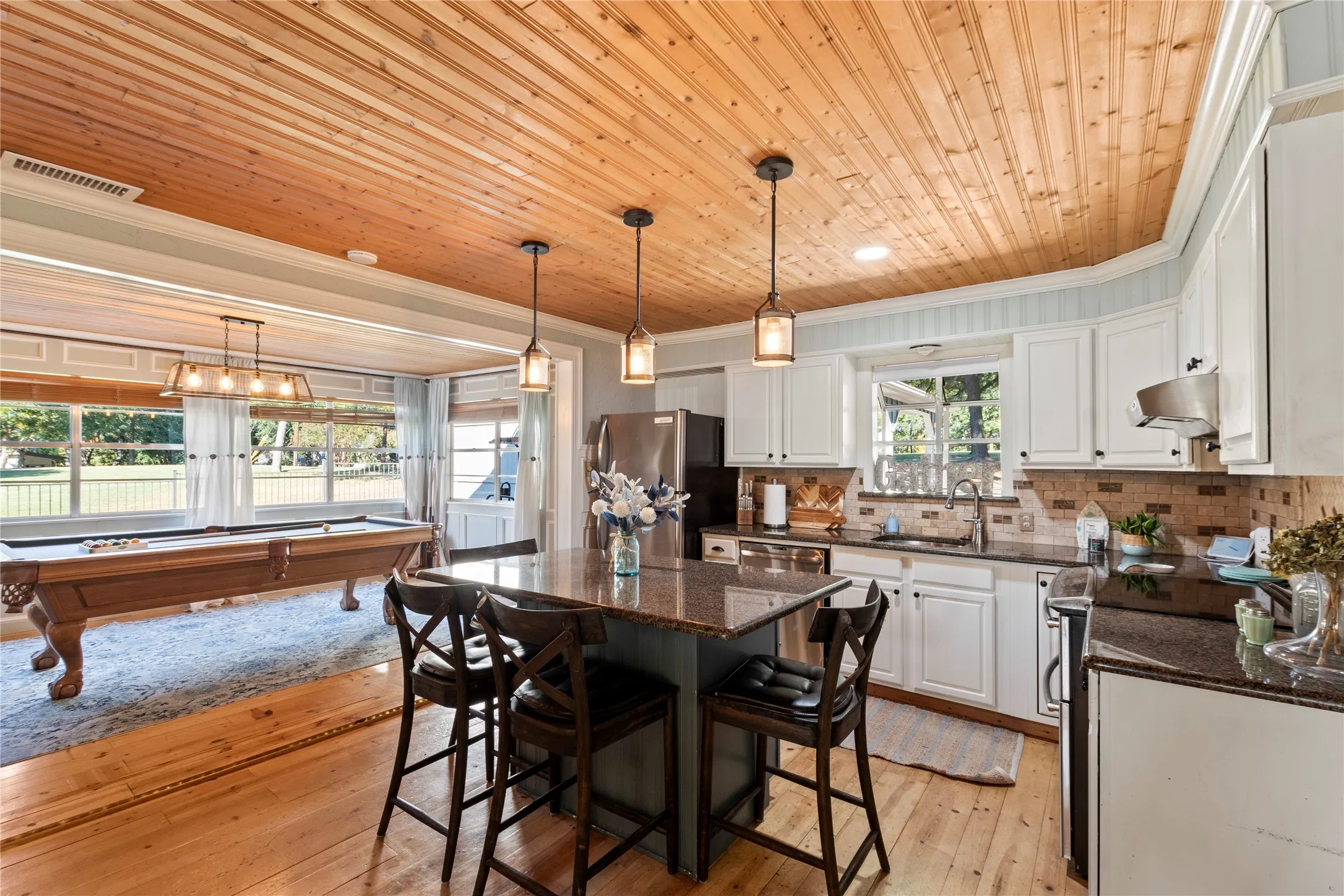 Open kitchen flowing seamlessly into the spacious game room and entertainment area