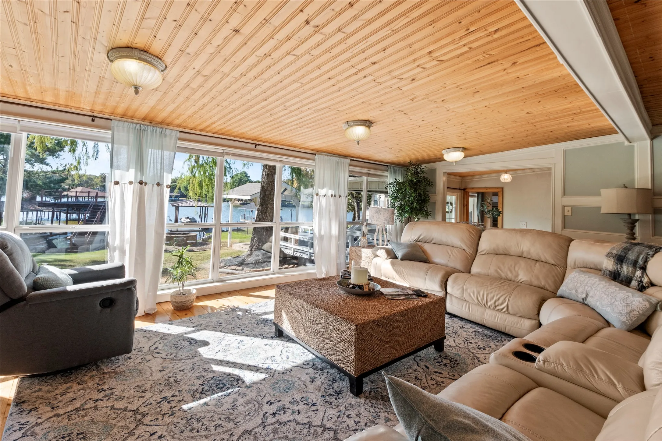 Open-concept living area with hardwood floors and panoramic lake views
