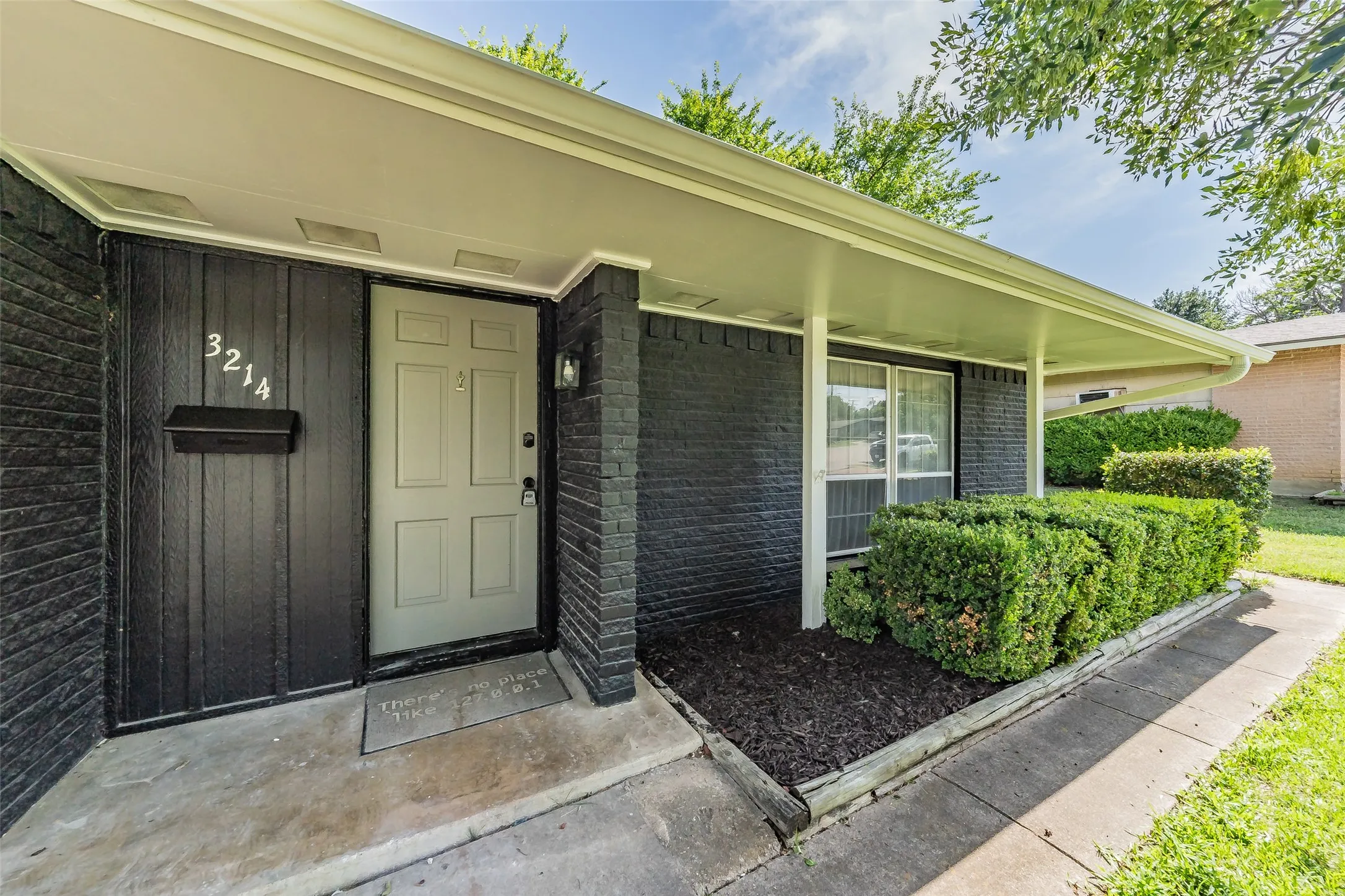 Contemporary exterior featuring black-painted brick and vertical siding